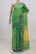 Pure Silk Green Paithani Saree with Zari Butta on the body and Zari Border.  displayed on a mannequin