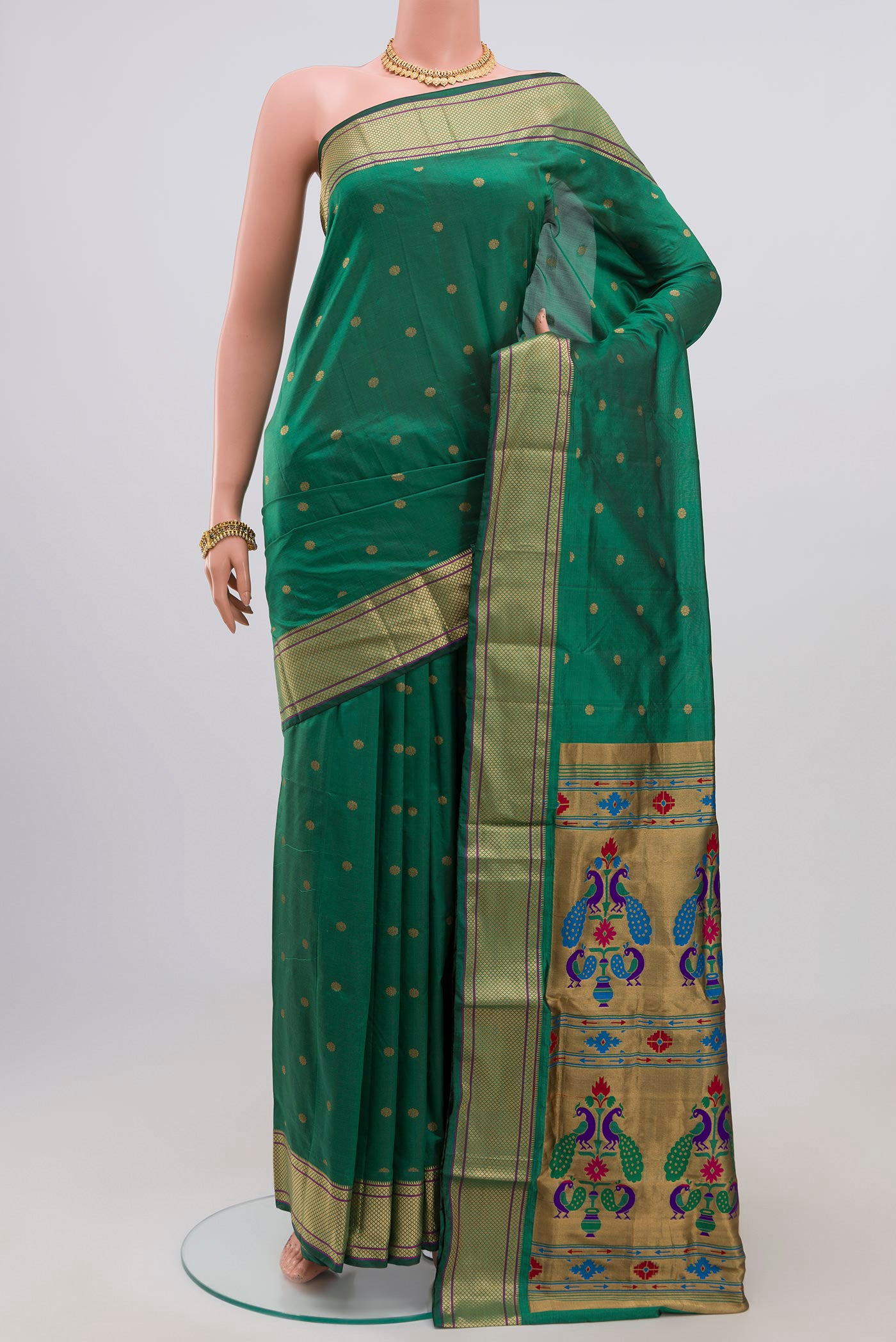 Green Bangalore Silk Saree with Zari Butta on the body and Zari Border.  displayed on a mannequin