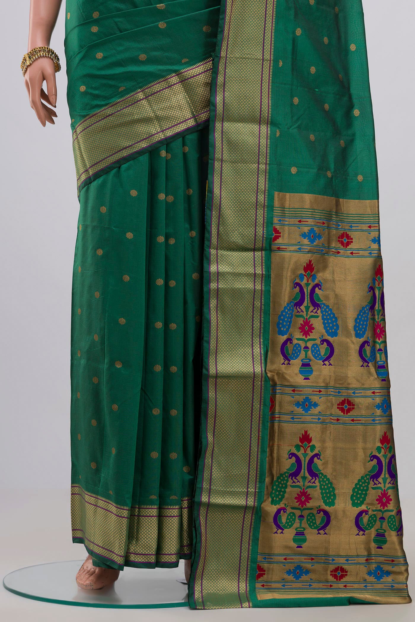 Pleats and pallu of Green Bangalore Silk Saree with Zari Butta on the body and Zari Border. 