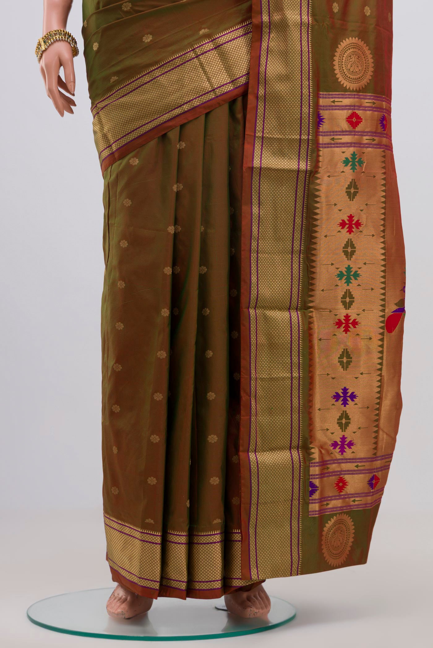 Pleats and pallu of Green Bangalore Silk Saree with Zari Butta on the body and Zari Border. 