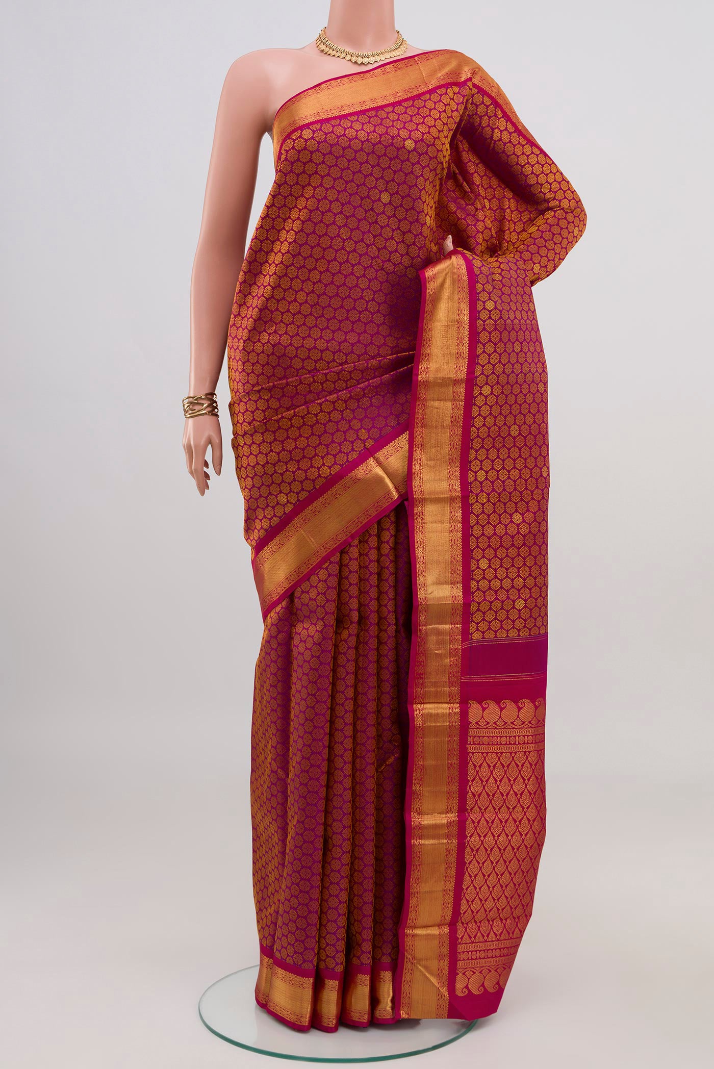 Pure Silk Pure Zari Magenta Kanjivaram Saree with Jacquard With Zari Butta on the body and Zari Border.  displayed on a mannequin