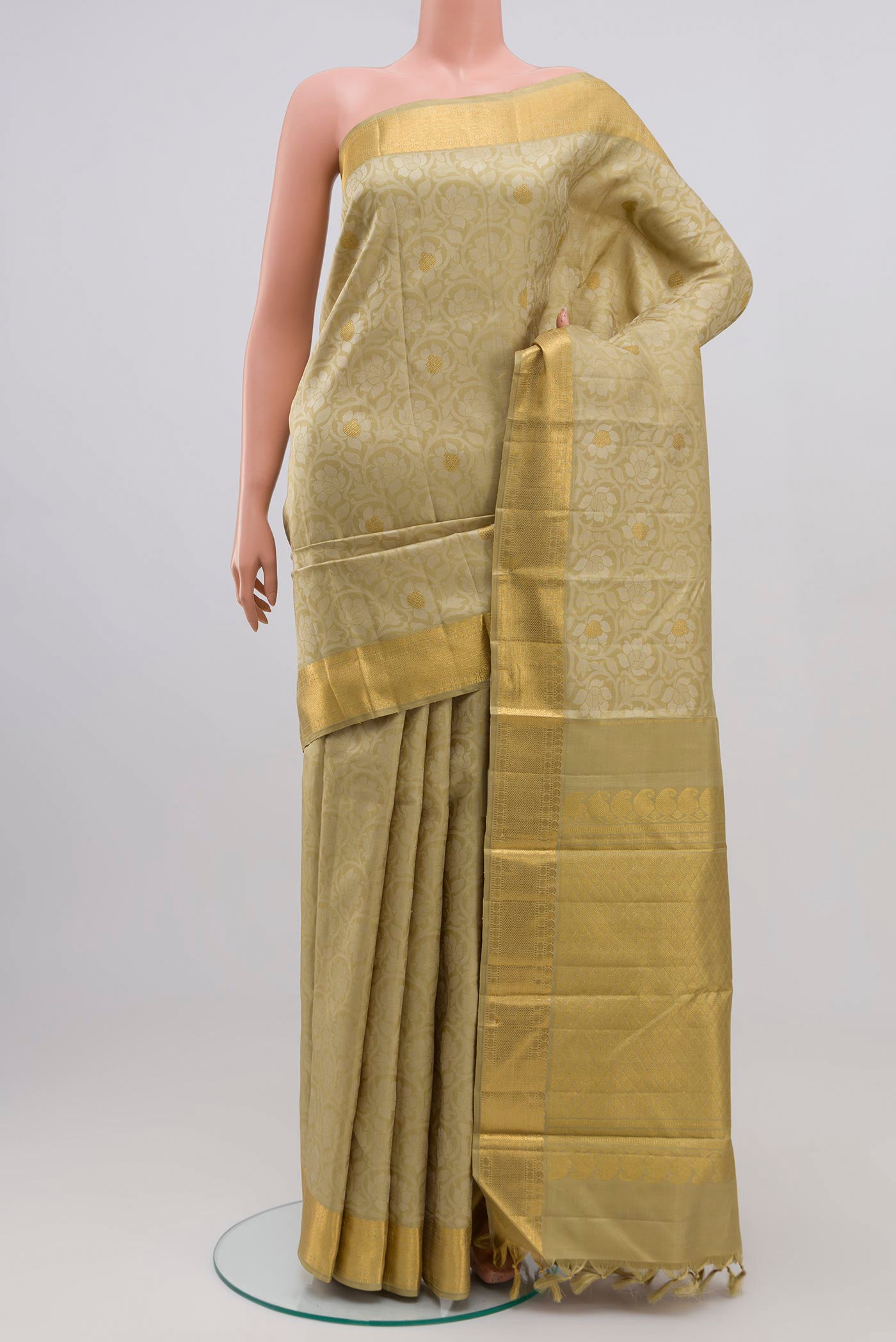 Pure Silk Pure Zari Green Kanjivaram Saree with Jacquard design on the body and Zari Border.  displayed on a mannequin