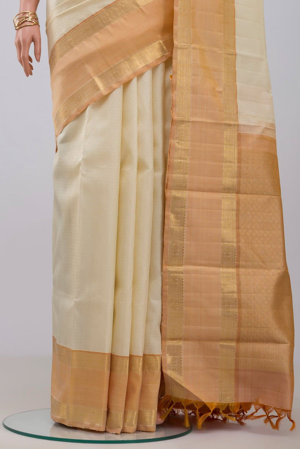 Pleats and pallu of Cream Kanjivaram Saree with Jacquard design on the body and Zari Border. 
