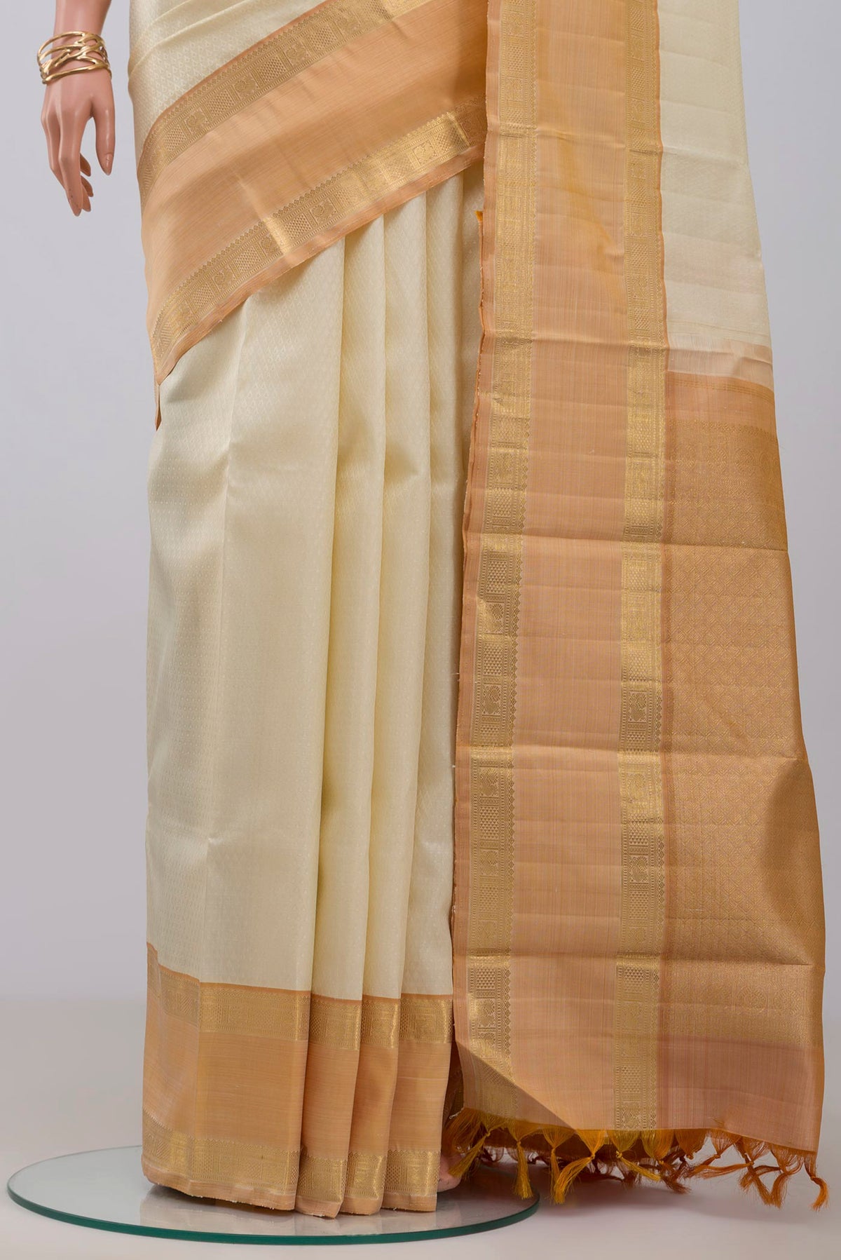 Pleats and pallu of Cream Kanjivaram Saree with Jacquard design on the body and Zari Border. 