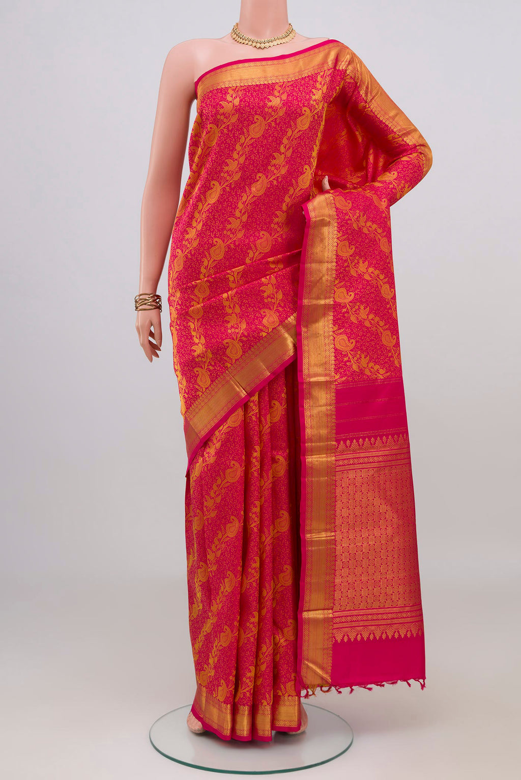 Pink Kanjivaram Silk Saree with Jacquard design on the body and Zari Border.  displayed on a mannequin