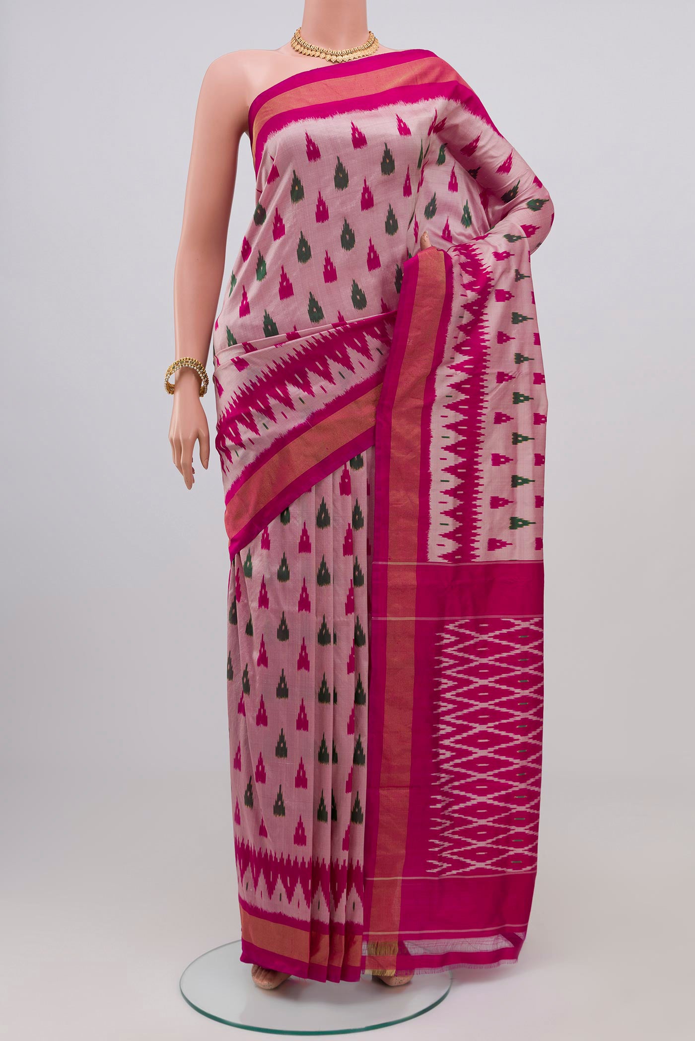 Rose pink Pochampally Silk Saree with Ikat Print on the body and Zari Border.  displayed on a mannequin