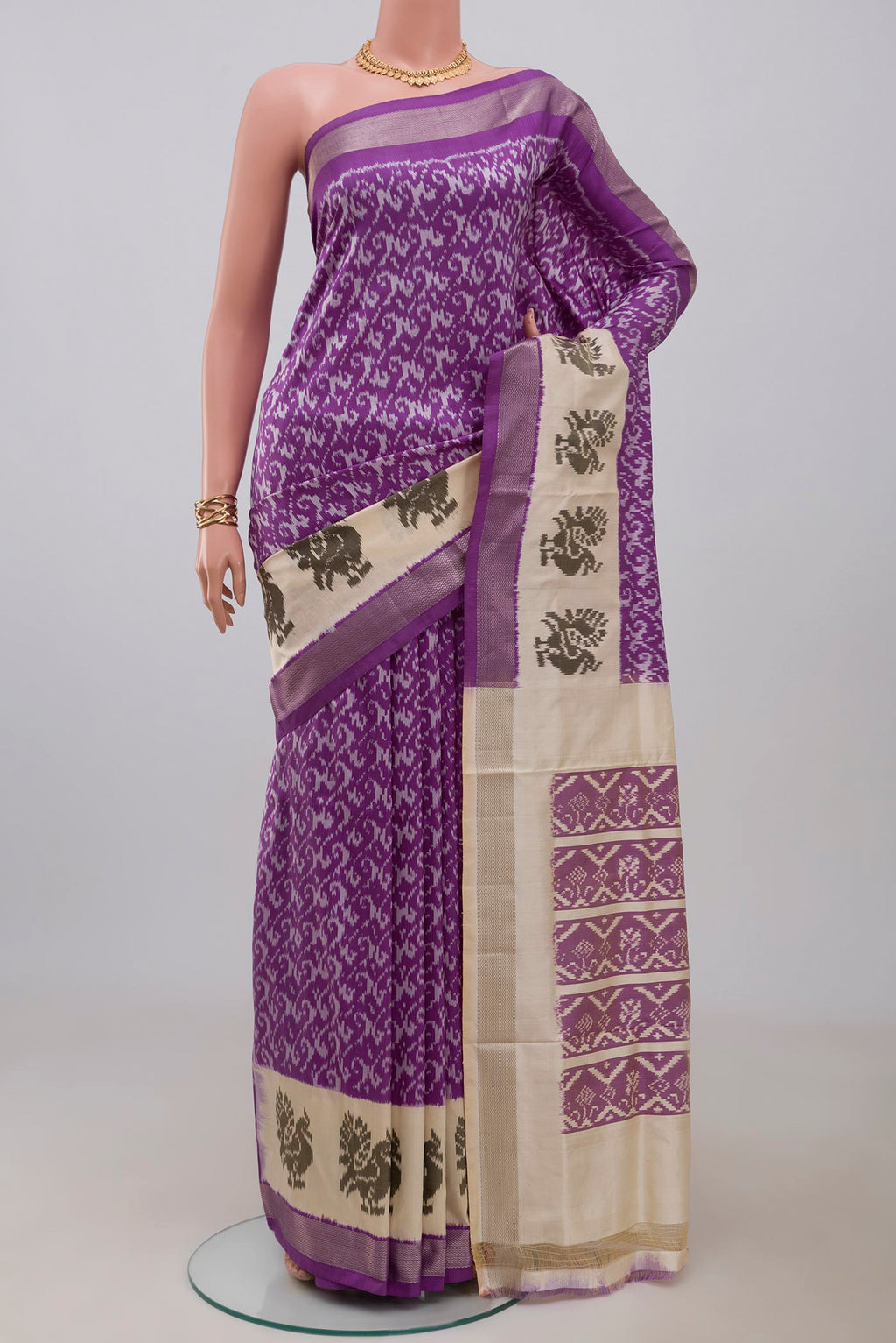 Purple Pochampally Saree with Ikat design on the body and Zari Border.  displayed on a mannequin