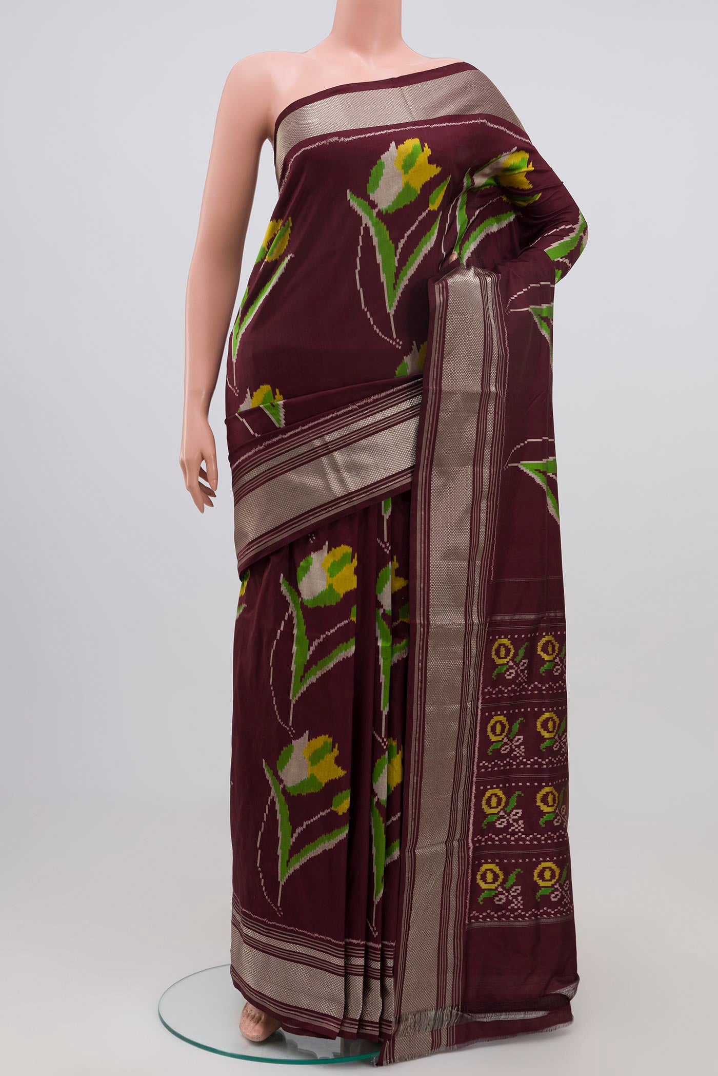 Brown Pochampally Silk Saree with Ikat Print on the body and Zari Border.  displayed on a mannequin