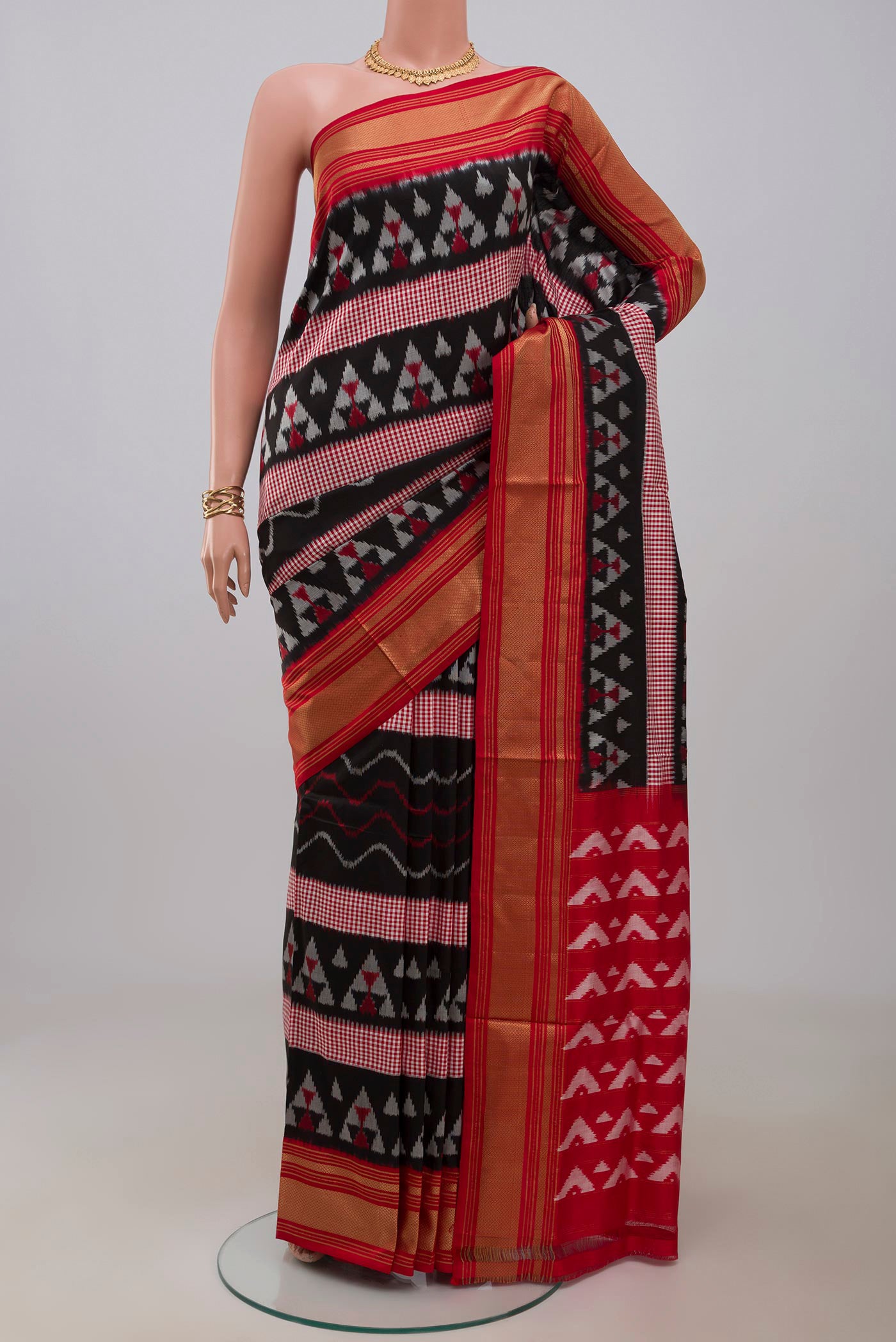 Black Pochampally Silk Saree with Pure Ikat on the body and Zari Border.  displayed on a mannequin