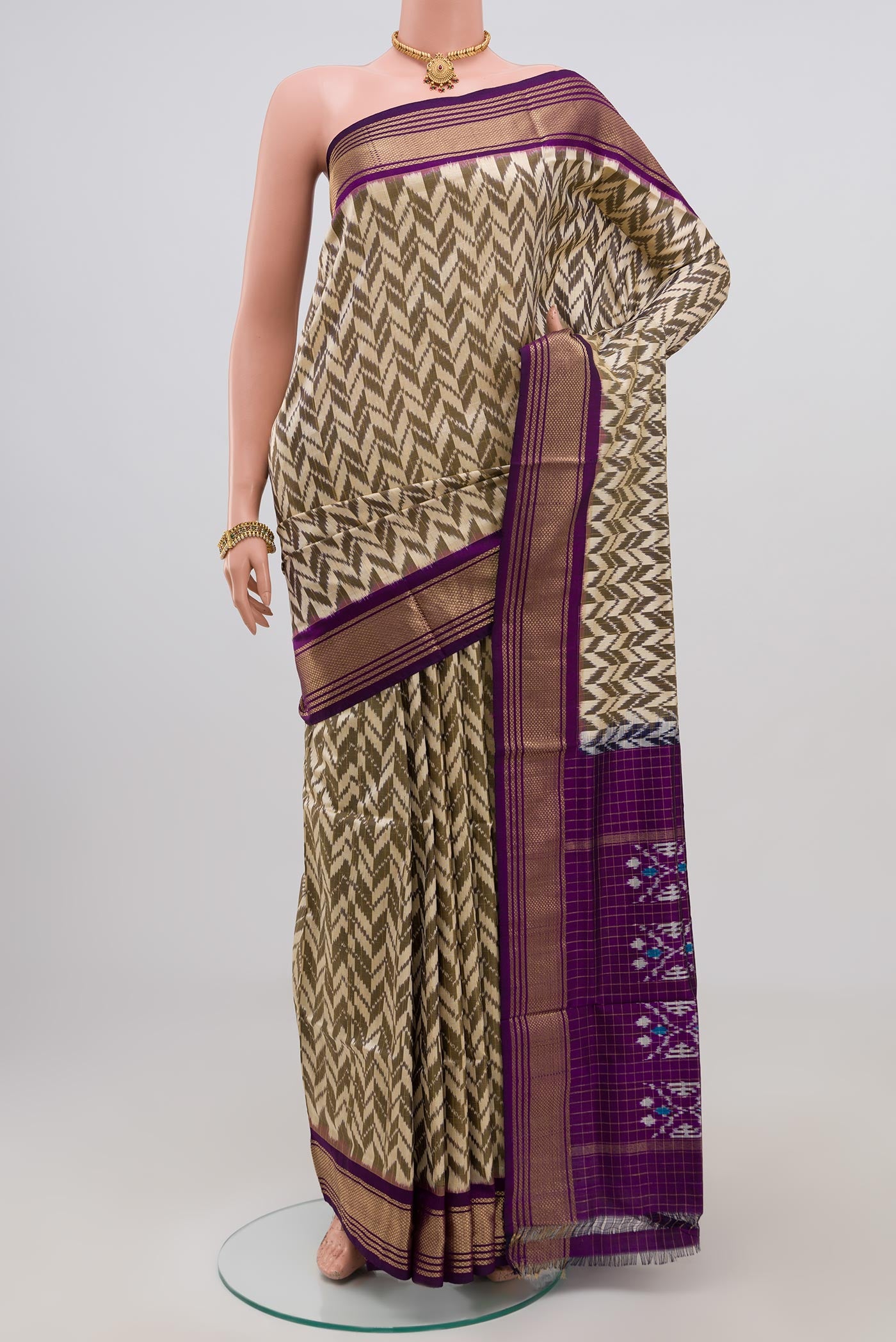 Cream Pochampally Silk Saree with Ikat Print on the body and Zari Border.  displayed on a mannequin