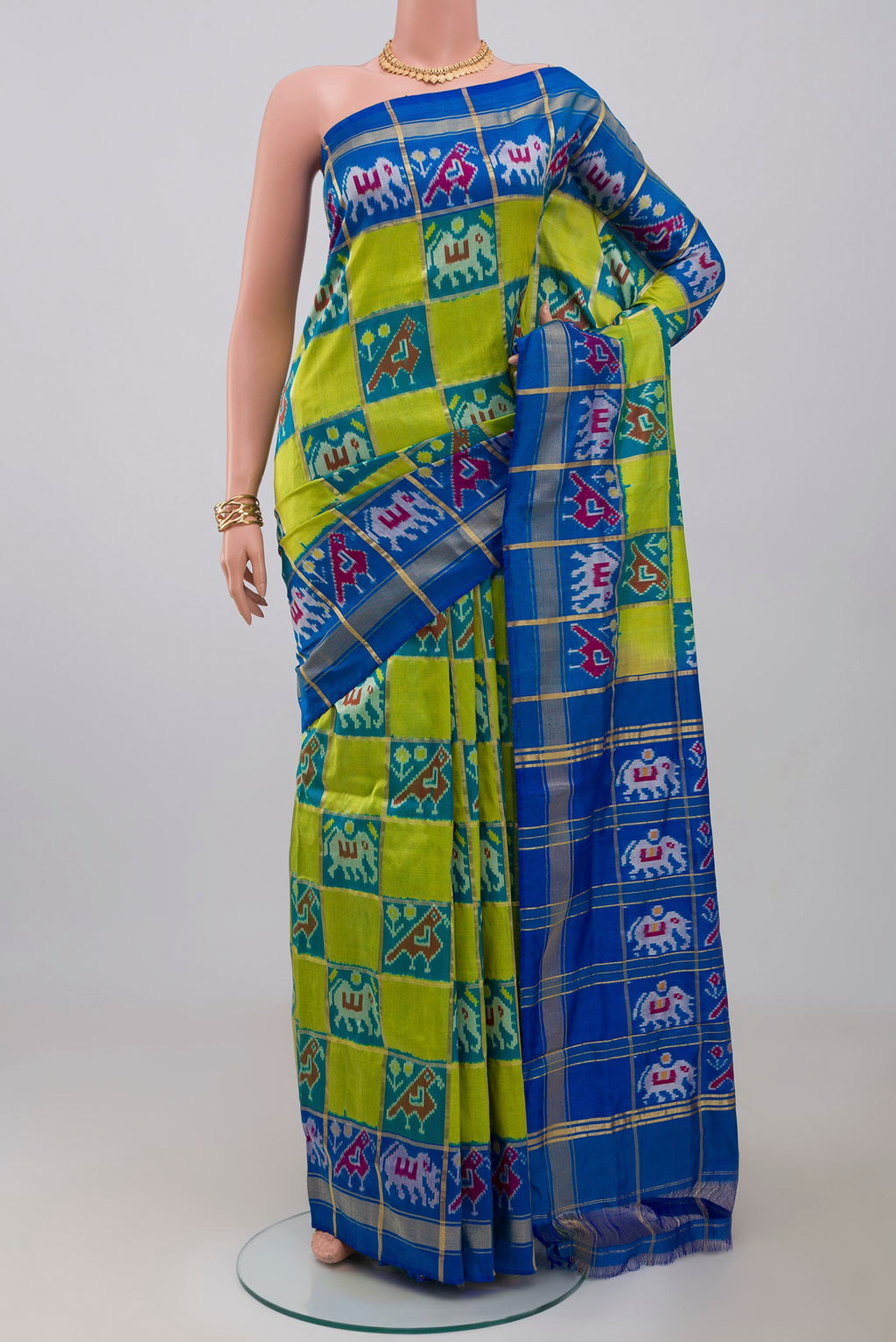 Green Pochampally Silk Saree with Ikat design on the body and Zari Border.  displayed on a mannequin