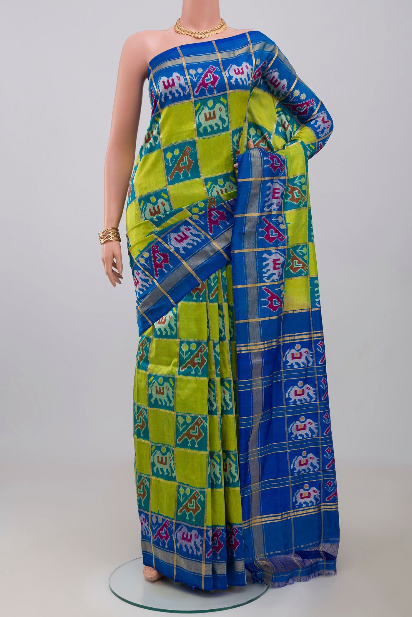 Green Pochampally Silk Saree with Ikat design on the body and Zari Border.  displayed on a mannequin