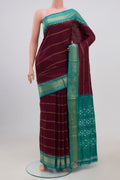 Maroon Pochampally Silk Saree with Stripes on the body and Zari Border.  displayed on a mannequin