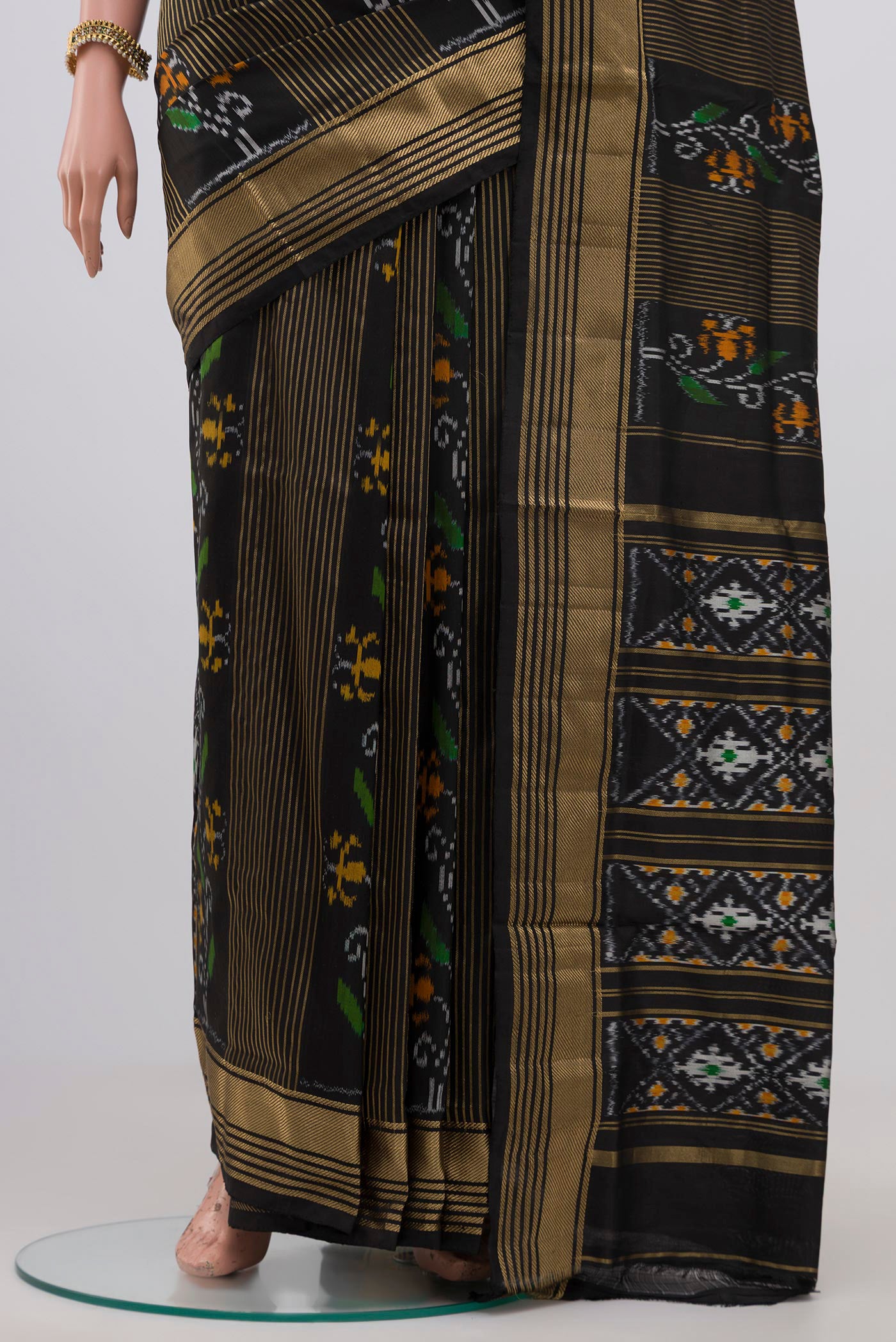 Pleats and pallu of Black Pochampally Silk Saree with Ikat Print on the body and Zari Border. 