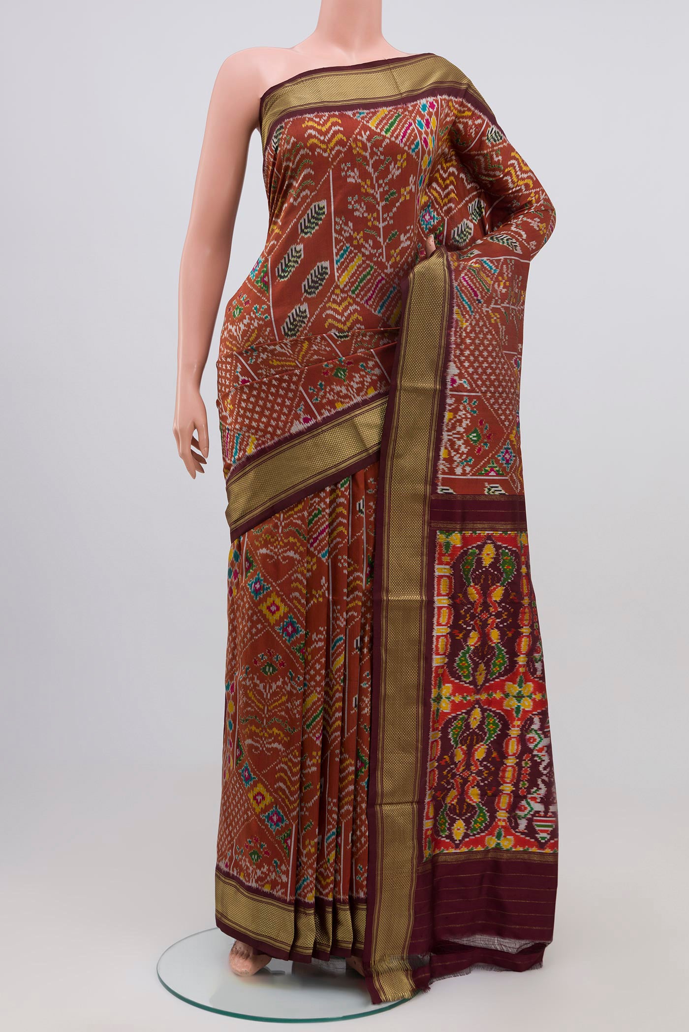 Brown Pochampally Silk Saree with Ikat Print on the body and Zari Border.  displayed on a mannequin