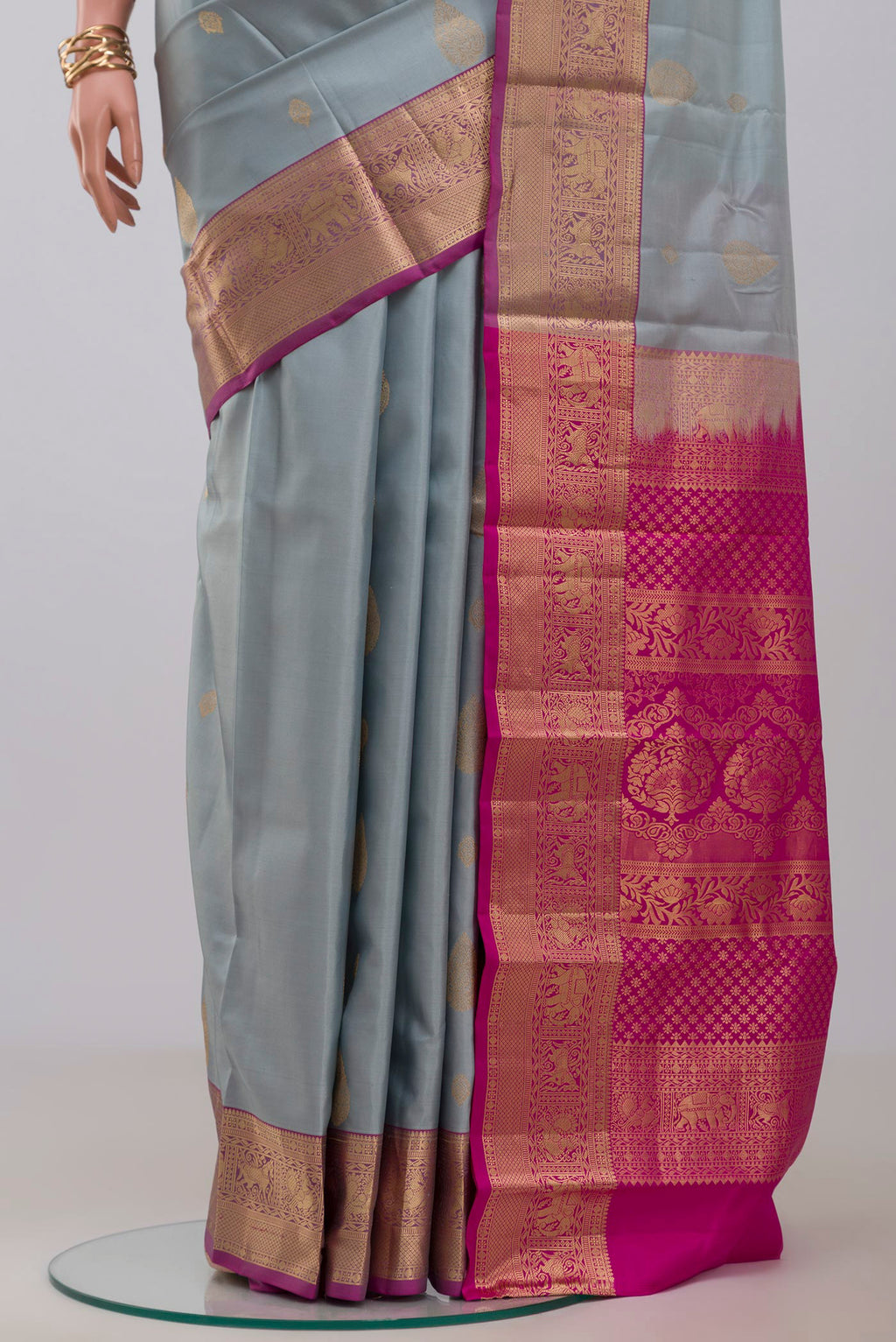 Pleats and pallu of Grey Kanjivaram Silk Saree with Zari Butta on the body and Zari Border. 