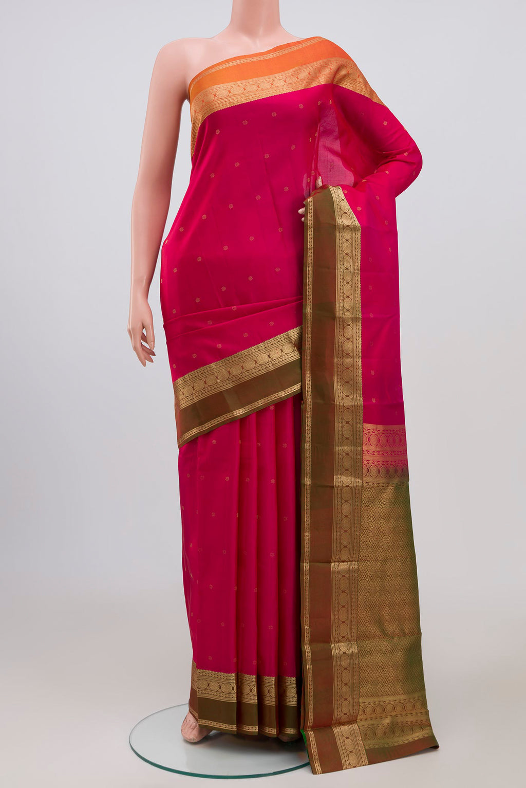 Pink Kanchipuram Saree with Zari Butta on the body and Zari Border.  displayed on a mannequin