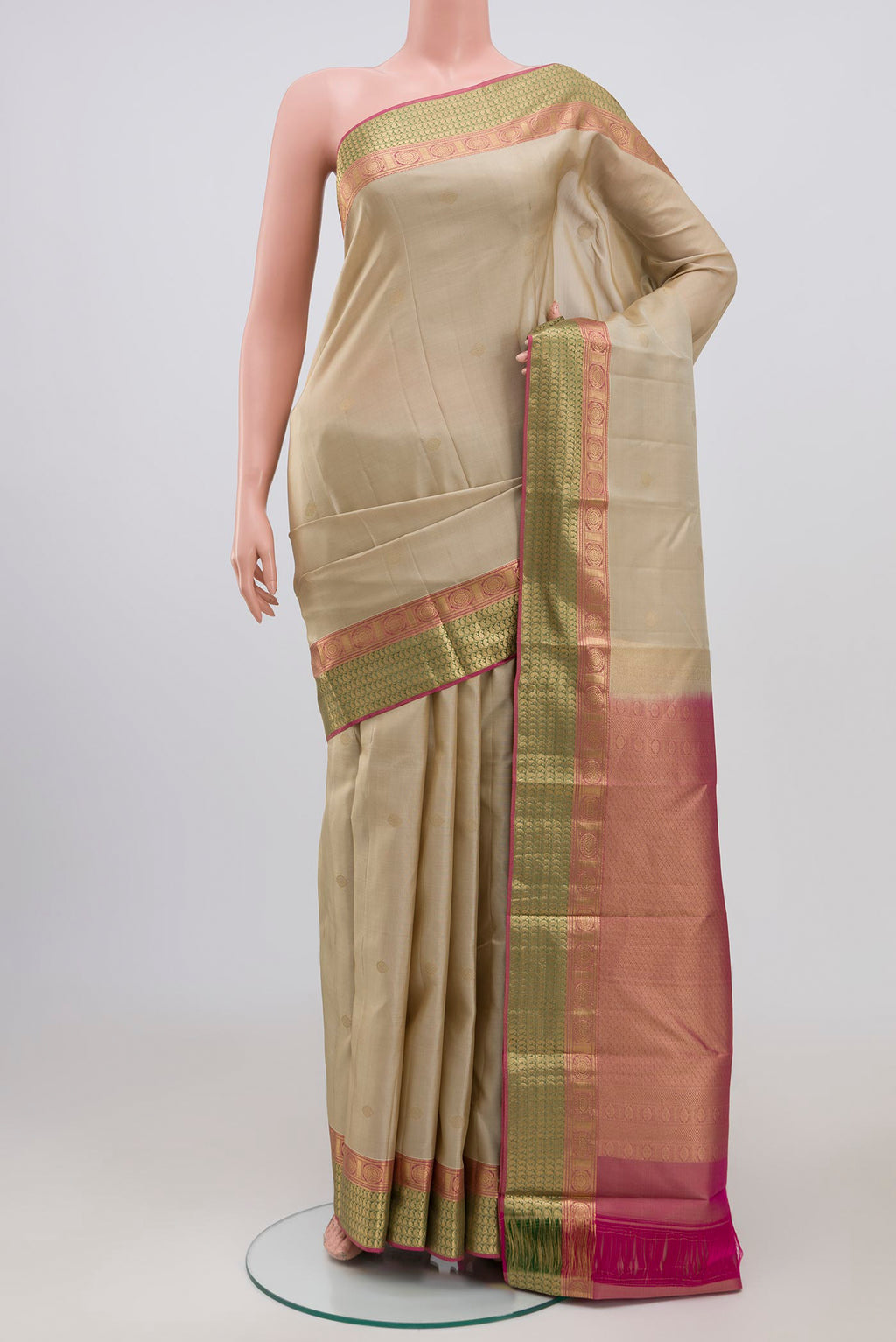Cream Kanchipuram Saree with Zari Butta on the body and Zari Border.  displayed on a mannequin