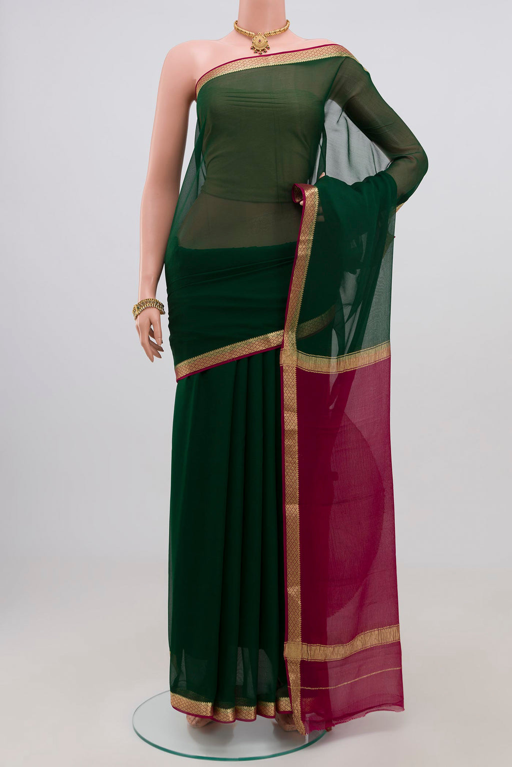 Green Chiffon Saree with Plain Body and Zari Border.  displayed on a mannequin