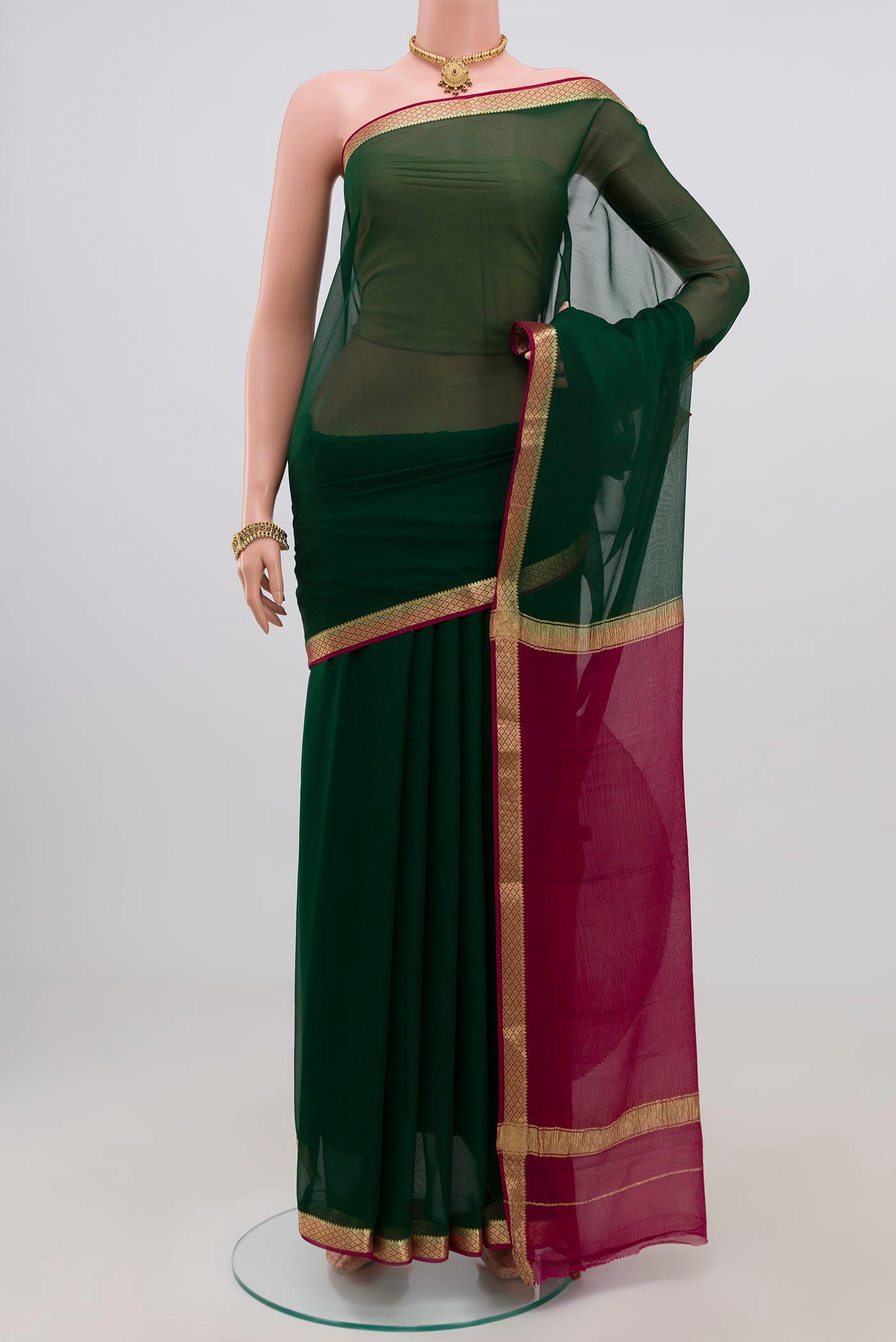 Green Chiffon Saree with Plain Body and Zari Border.  displayed on a mannequin
