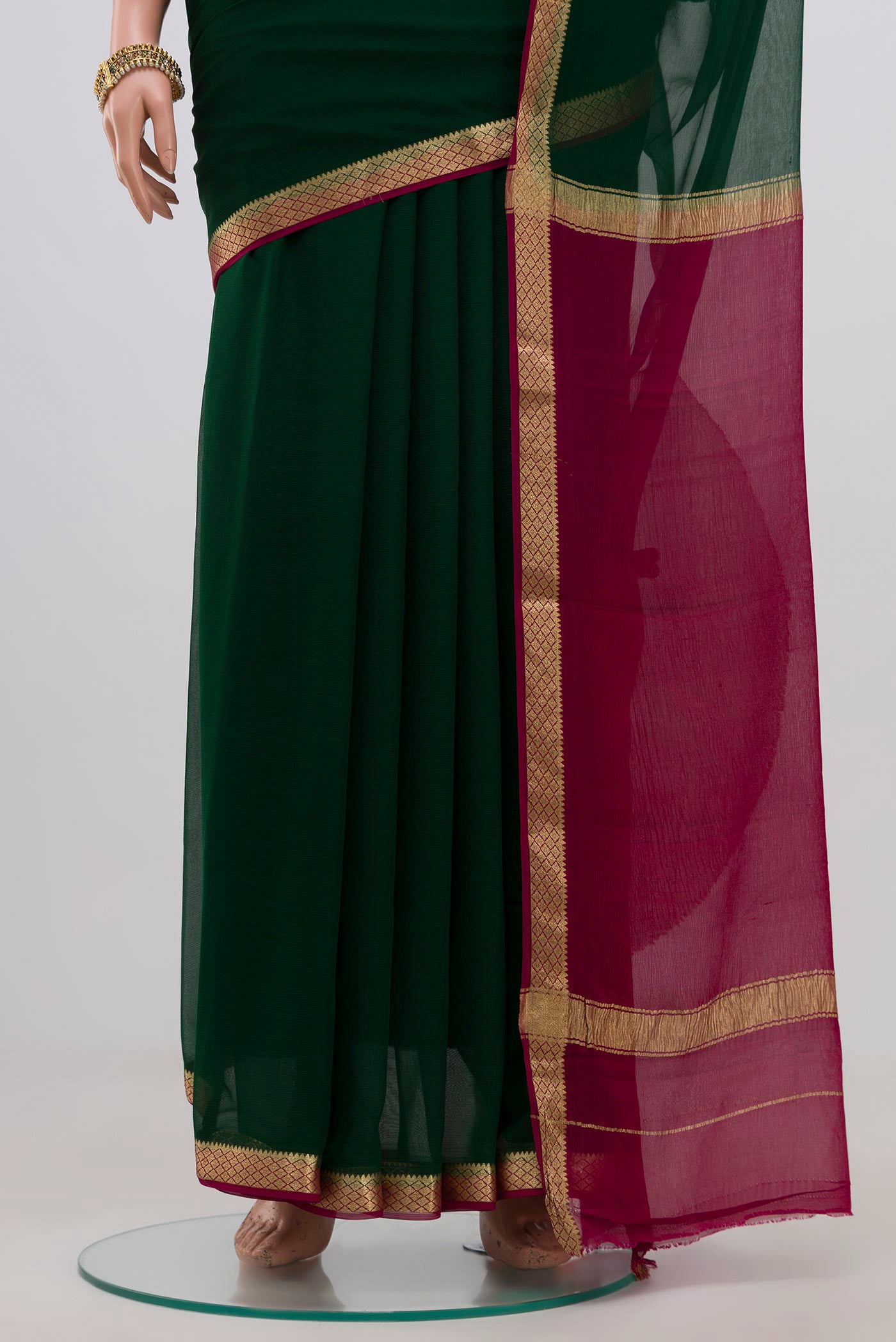 Pleats and pallu of Green Chiffon Saree with Plain Body and Zari Border. 