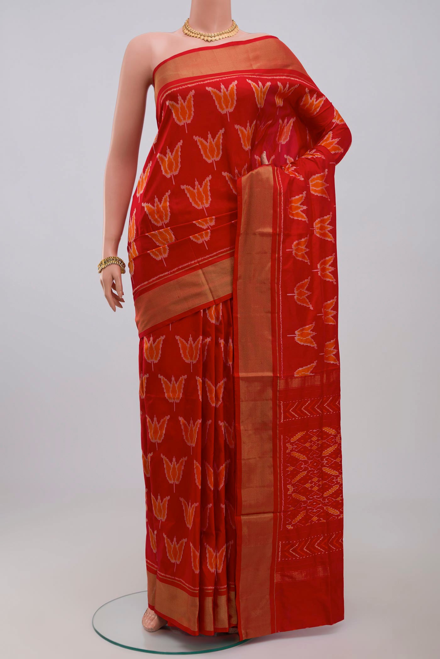 Red Pochampally Saree with Ikat design on the body and Zari Border.  displayed on a mannequin