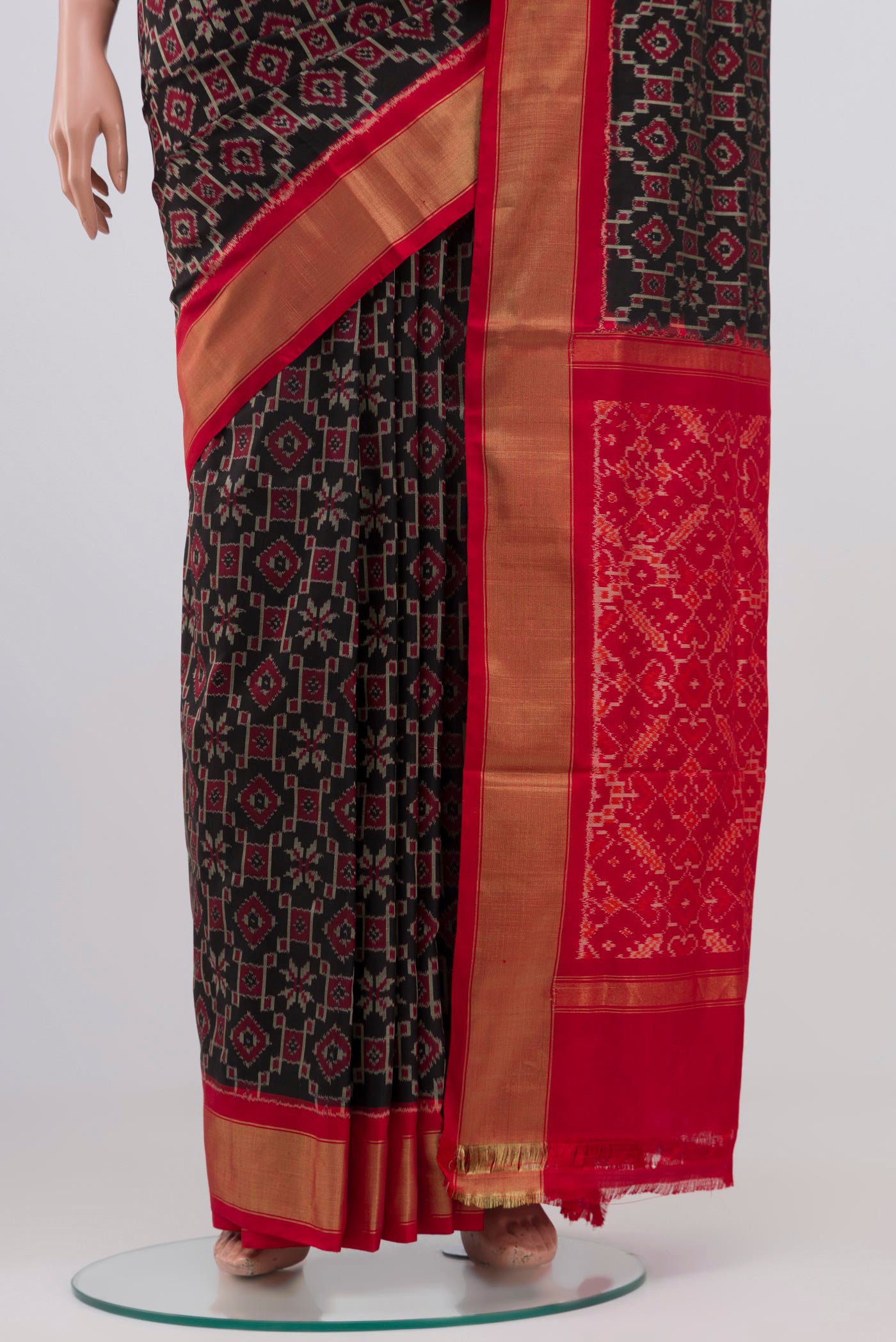 Pleats and pallu of Black Pochampally Silk Saree with Ikat design on the body and Zari Border. 