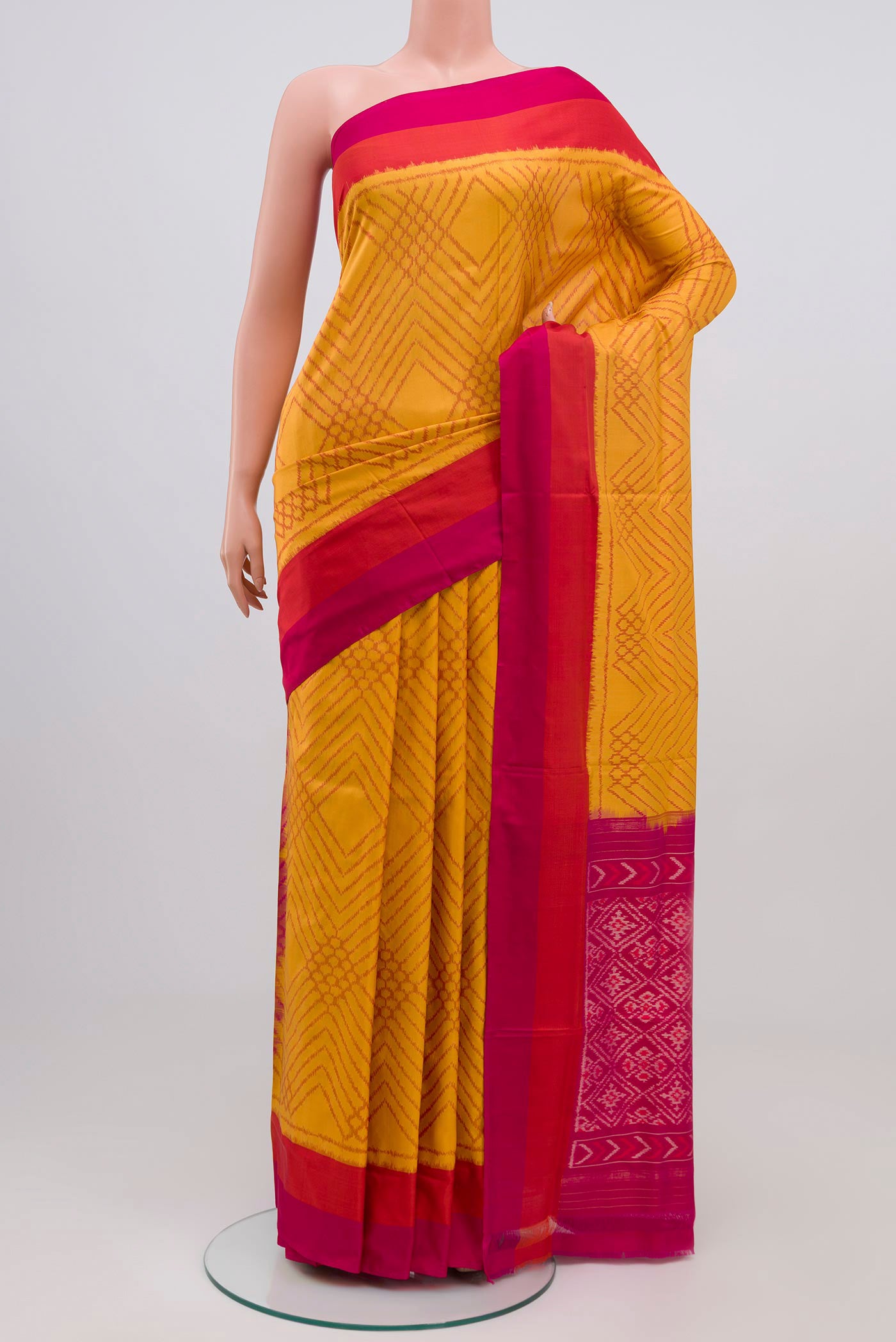 Yellow Pochampally Silk Saree with Ikat Print on the body and Zari Border.  displayed on a mannequin