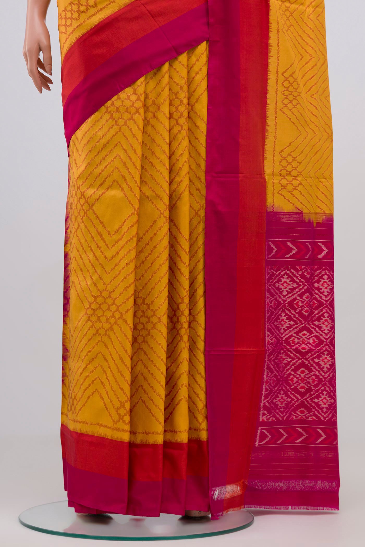 Pleats and pallu of Yellow Pochampally Silk Saree with Ikat Print on the body and Zari Border. 