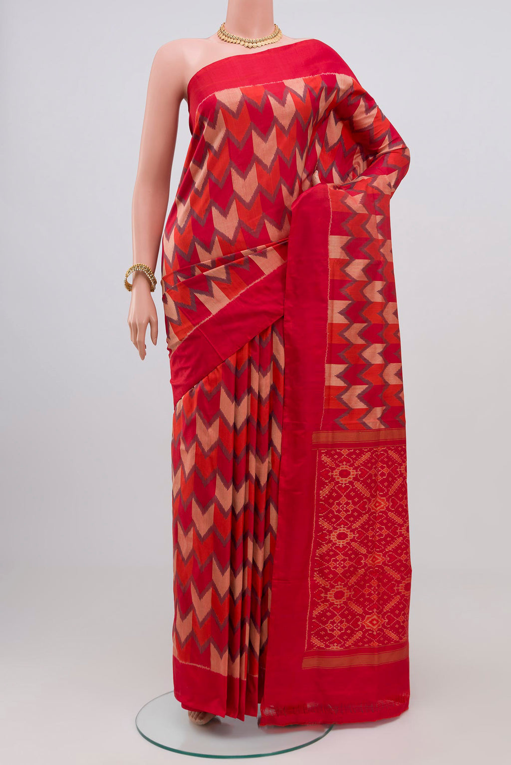 Red Pochampally Silk Saree with Ikat Print on the body and Plain Border.  displayed on a mannequin