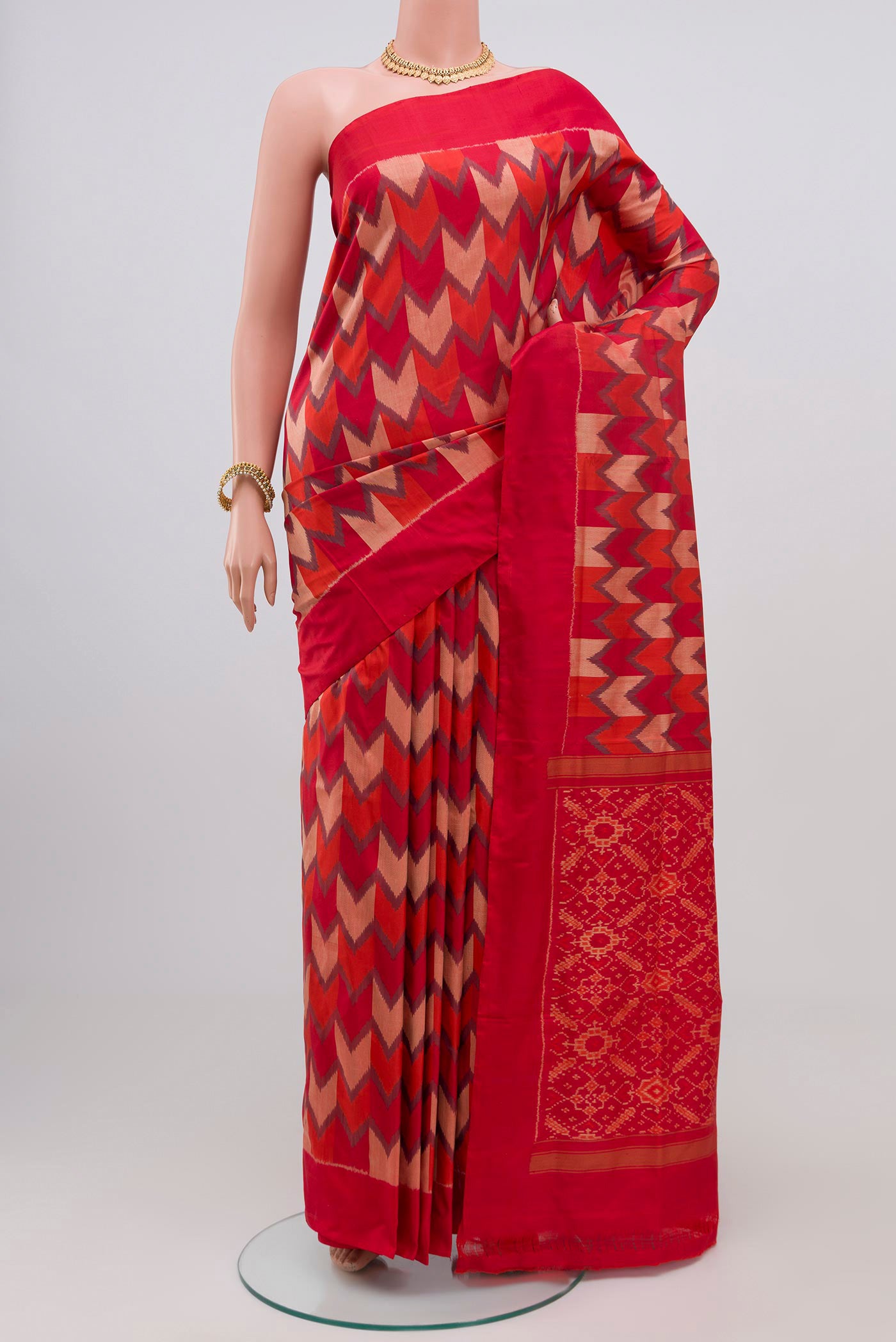 Red Pochampally Silk Saree with Ikat Print on the body and Plain Border.  displayed on a mannequin