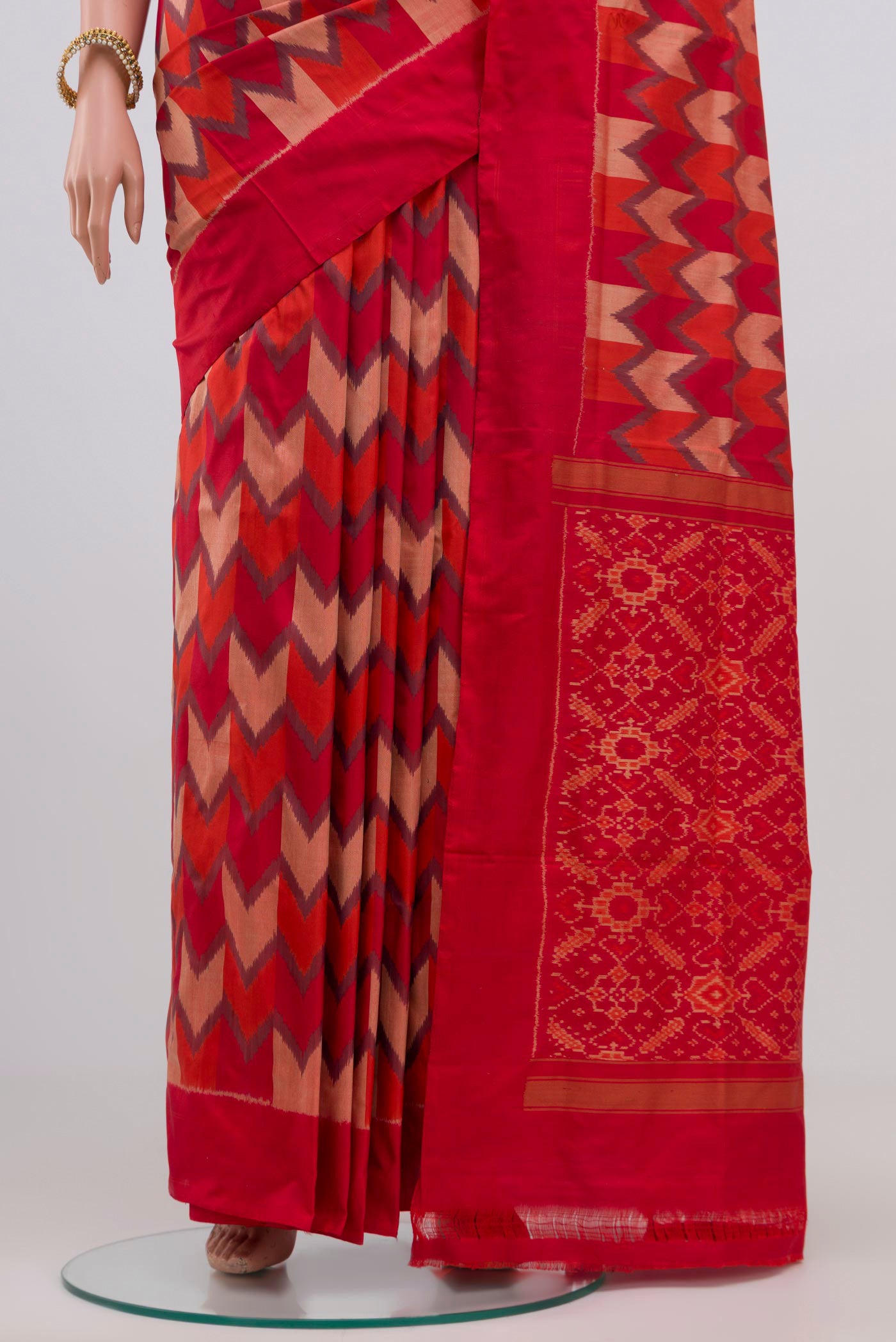 Pleats and pallu of Red Pochampally Silk Saree with Ikat Print on the body and Plain Border. 