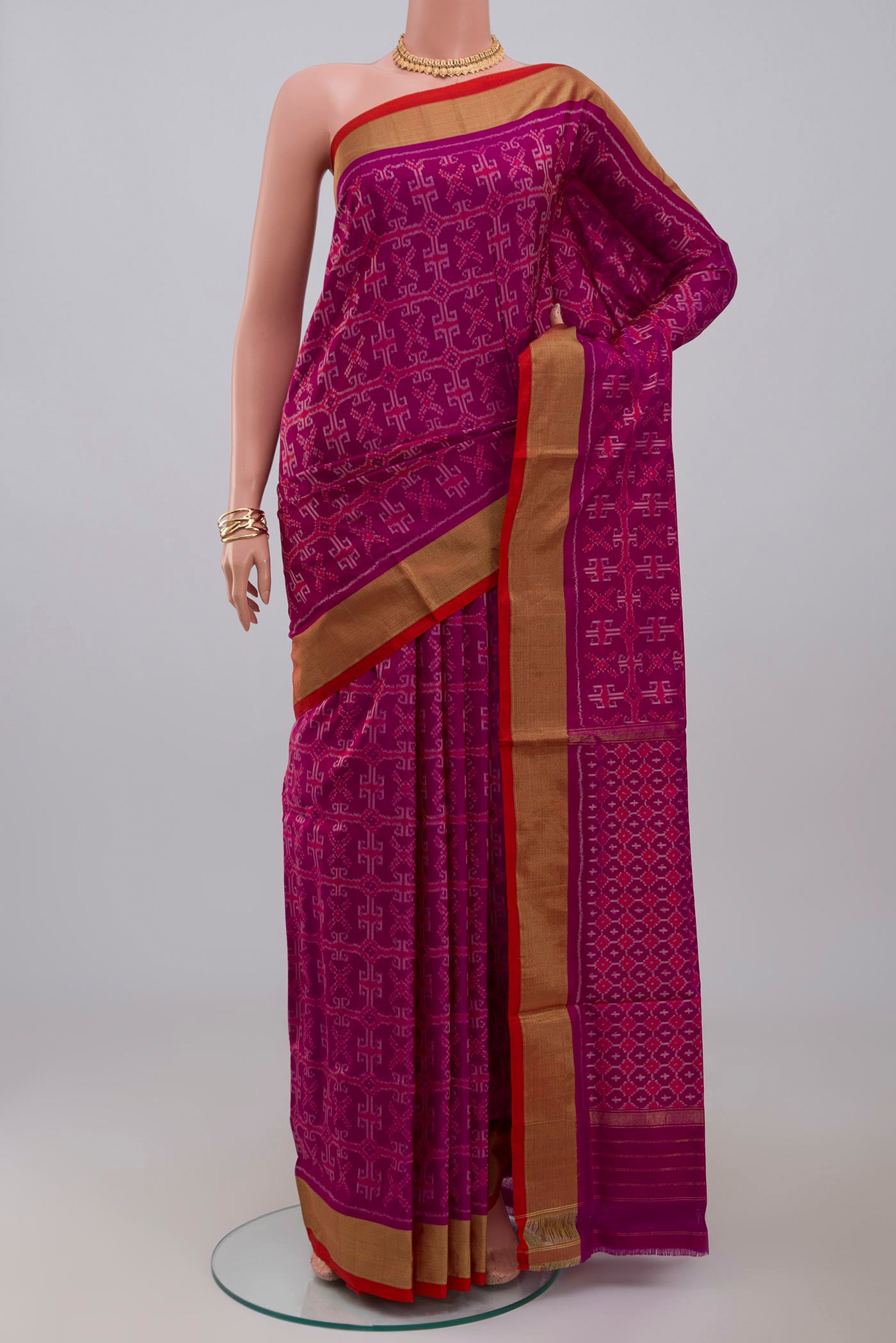 Purple Pochampally Silk Saree with Ikat design on the body and Zari Border.  displayed on a mannequin