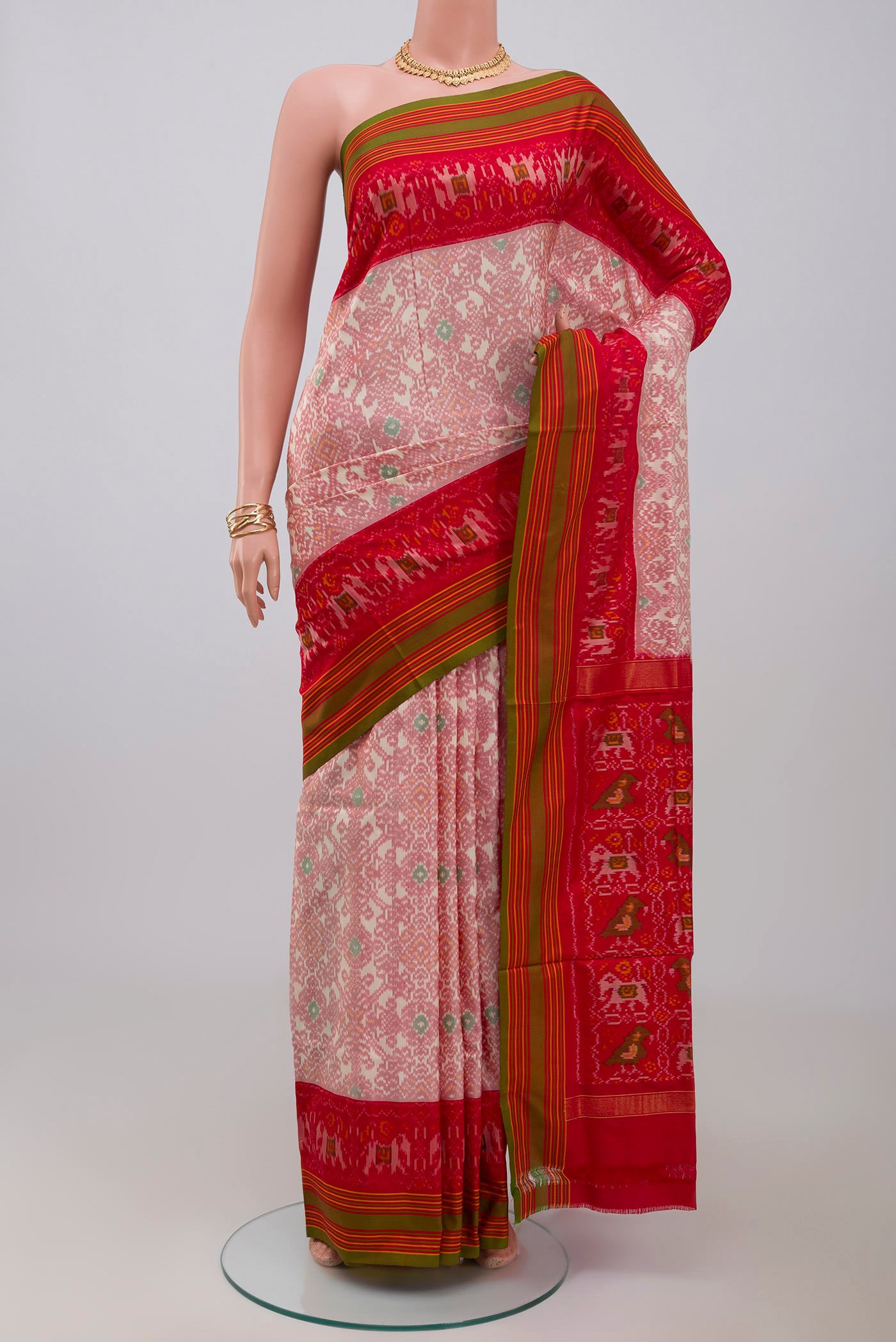 Peach Pochampally Silk Saree with Ikat design on the body and Plain Border.  displayed on a mannequin