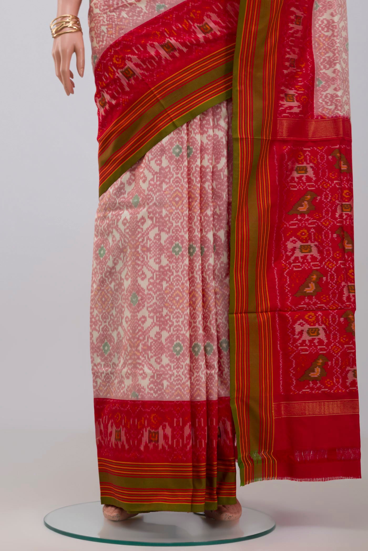 Pleats and pallu of Peach Pochampally Silk Saree with Ikat design on the body and Plain Border. 