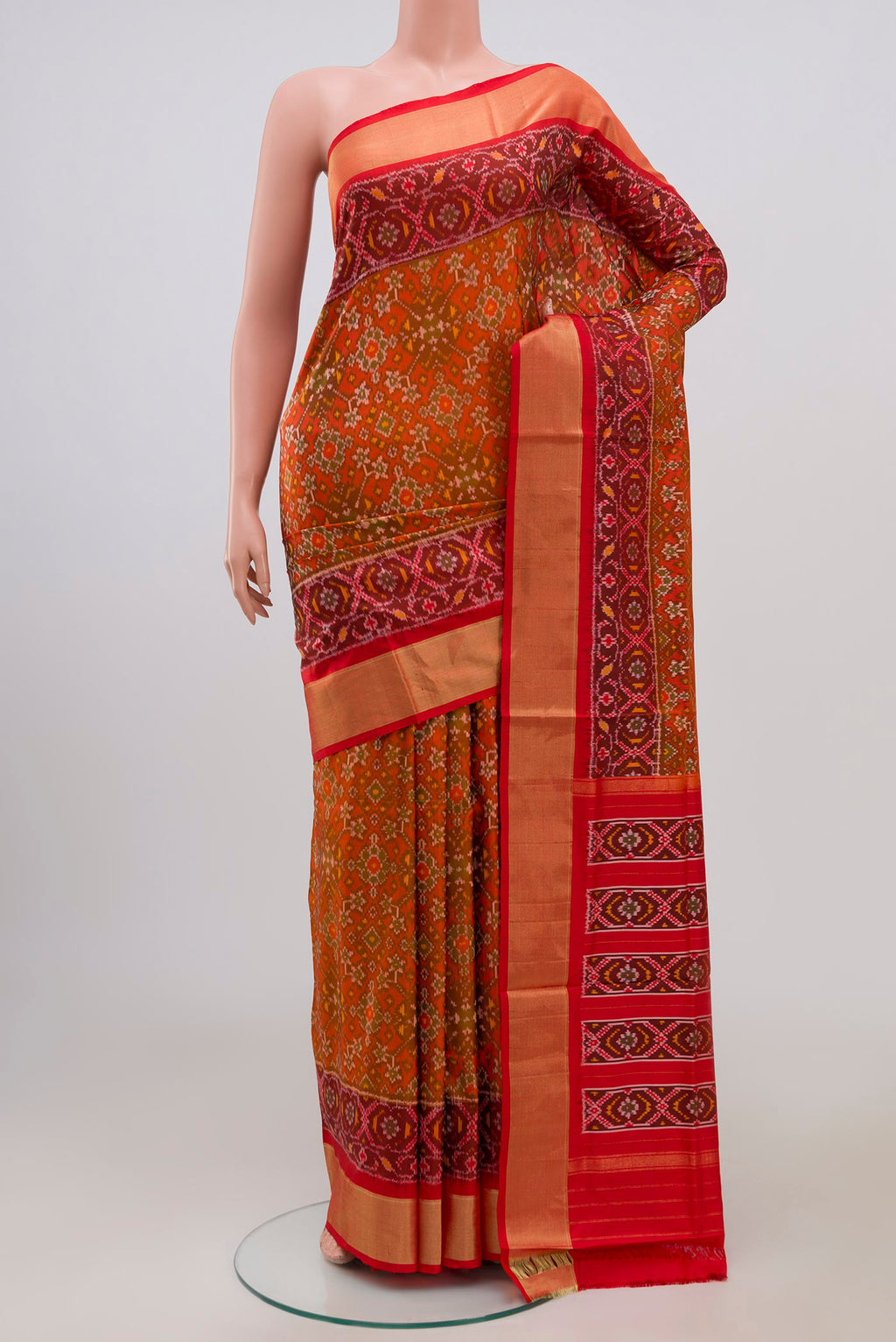 Red Pochampally Silk Saree with Ikat Print on the body and Zari Border.  displayed on a mannequin