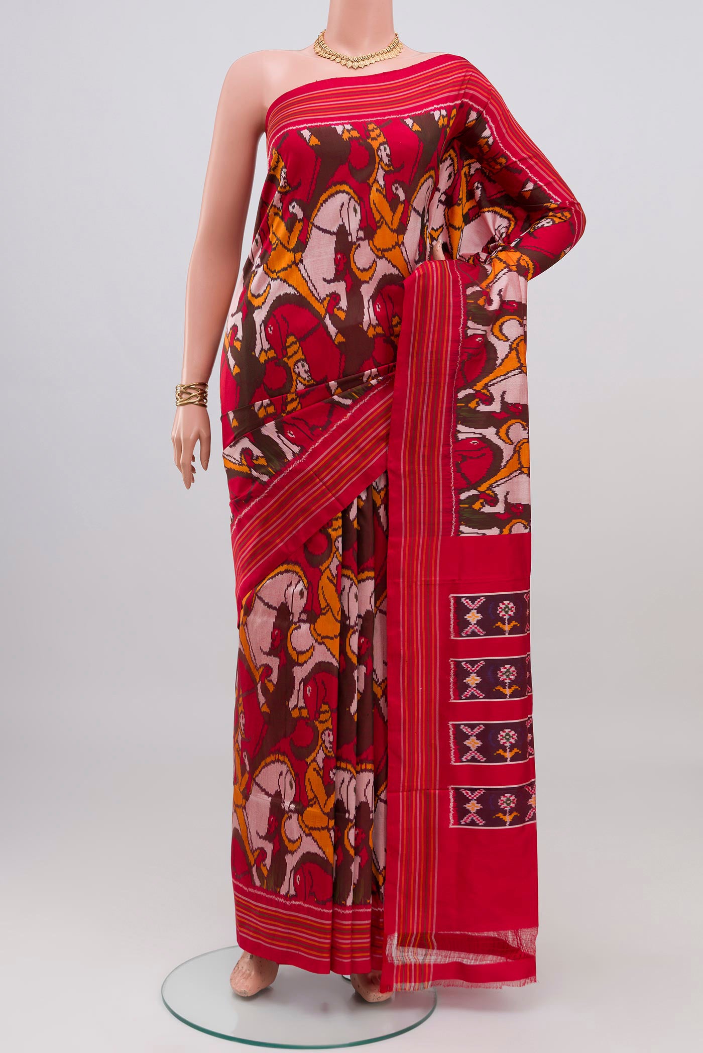 Red Pochampally Silk Saree with Pure Ikat on the body and Plain Border.  displayed on a mannequin