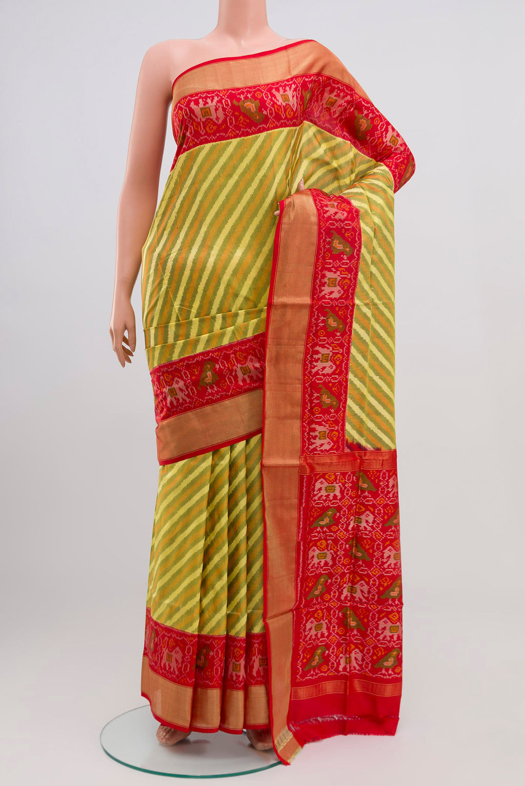 Green Pochampally Silk Saree with Ikat Print on the body and Zari Border.  displayed on a mannequin