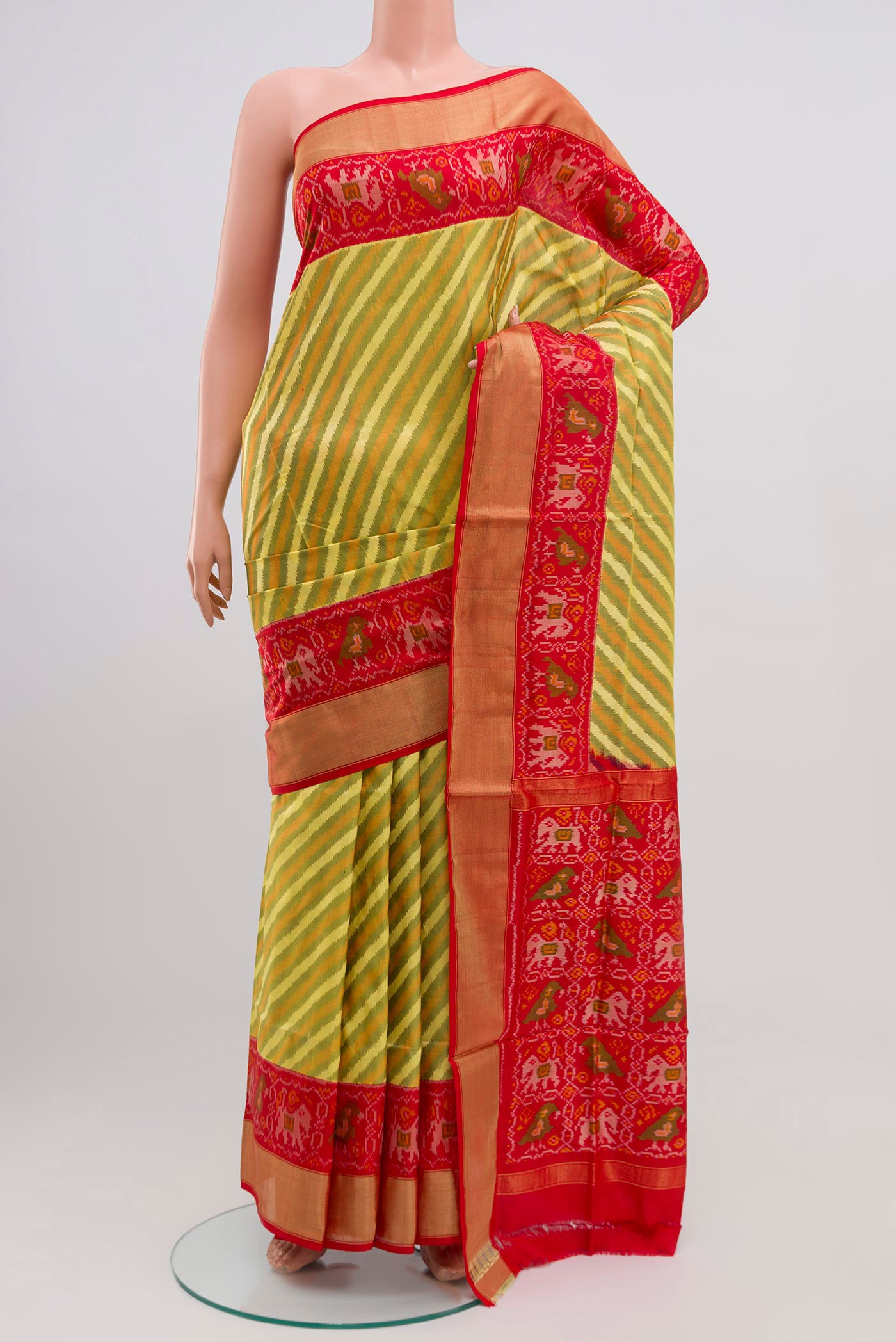 Green Pochampally Silk Saree with Ikat Print on the body and Zari Border.  displayed on a mannequin
