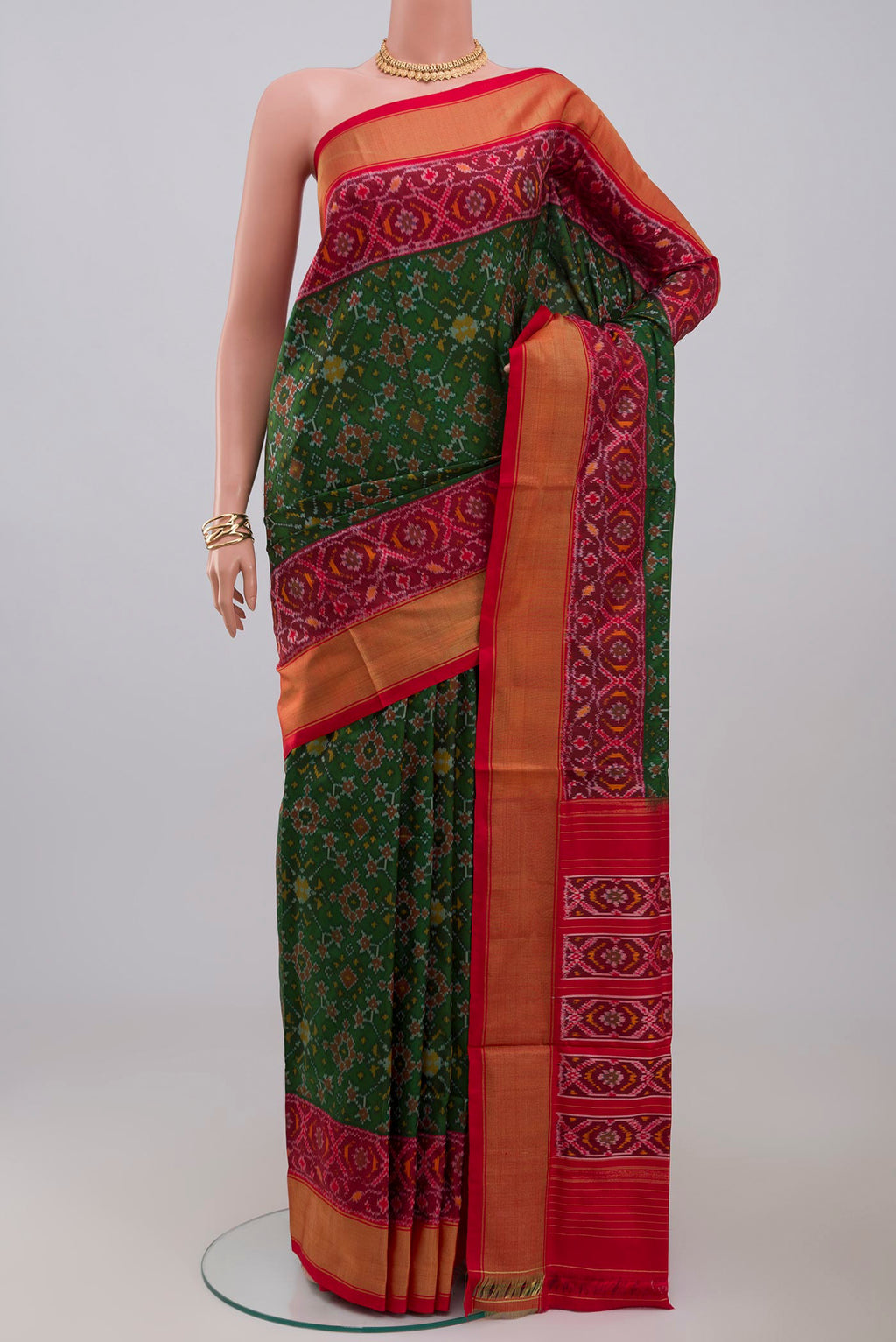Green Pochampally Silk Saree with Ikat design on the body and Zari Border.  displayed on a mannequin
