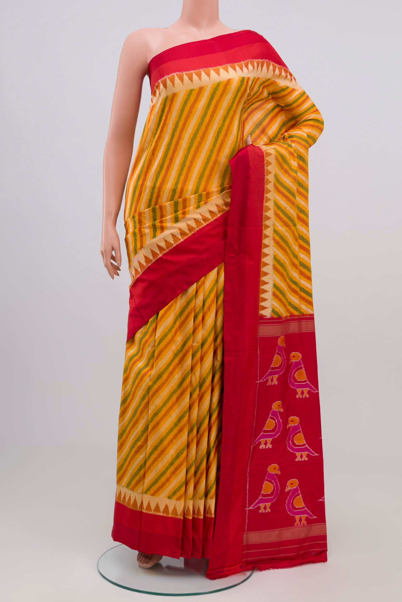 Yellow Pochampally Silk Saree with Ikat Print on the body and Zari Border.  displayed on a mannequin