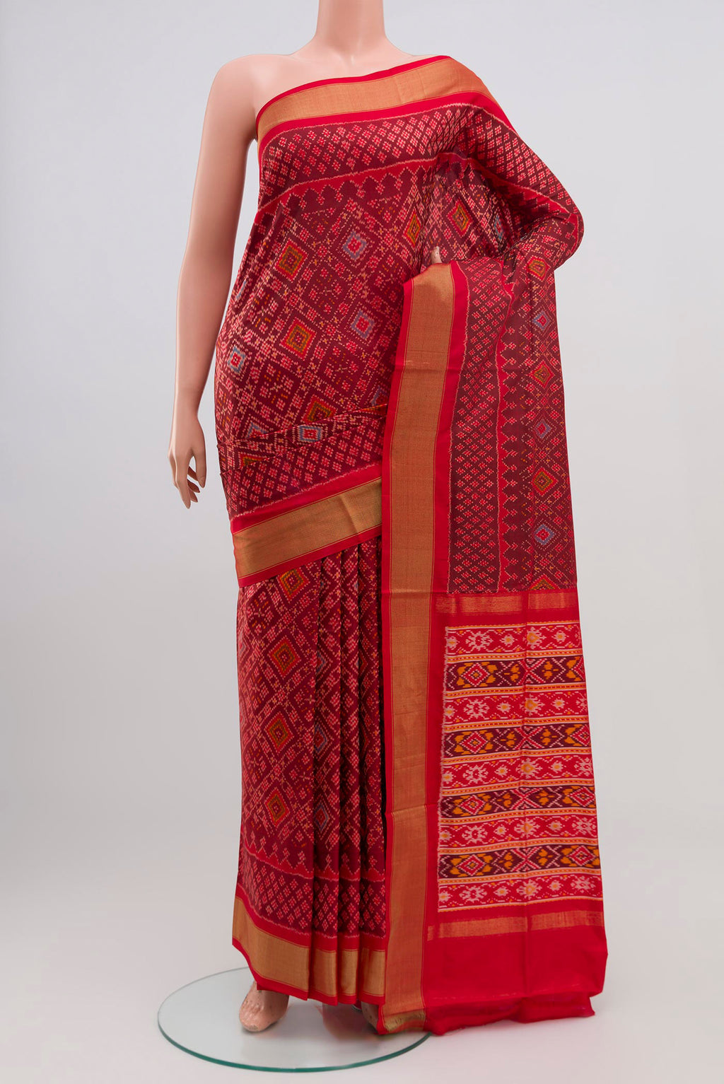 Red Pochampally Silk Saree with Ikat Print on the body and Zari Border.  displayed on a mannequin