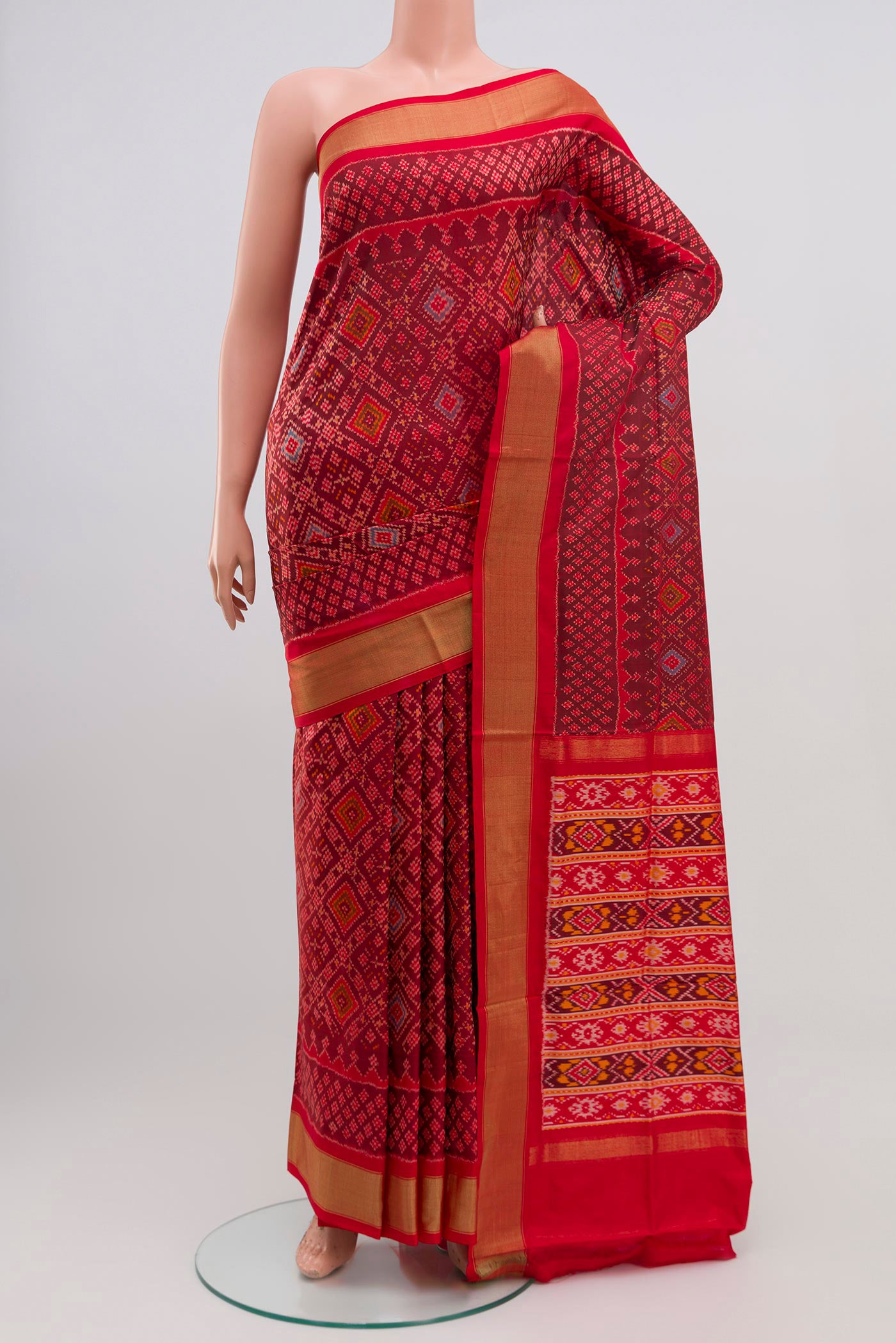 Red Pochampally Silk Saree with Ikat Print on the body and Zari Border.  displayed on a mannequin