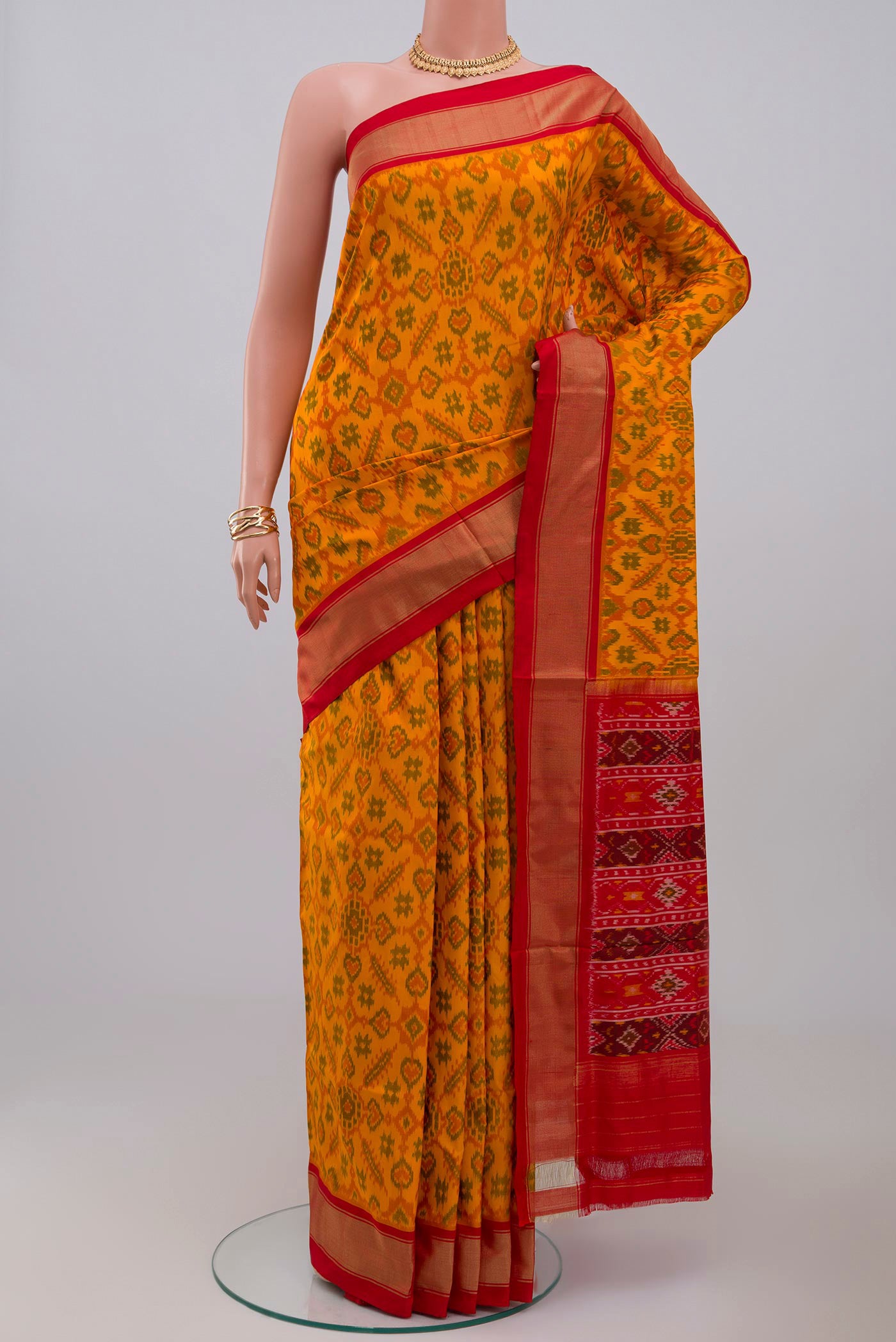 Yellow Pochampally Silk Saree with Ikat design on the body and Zari Border.  displayed on a mannequin