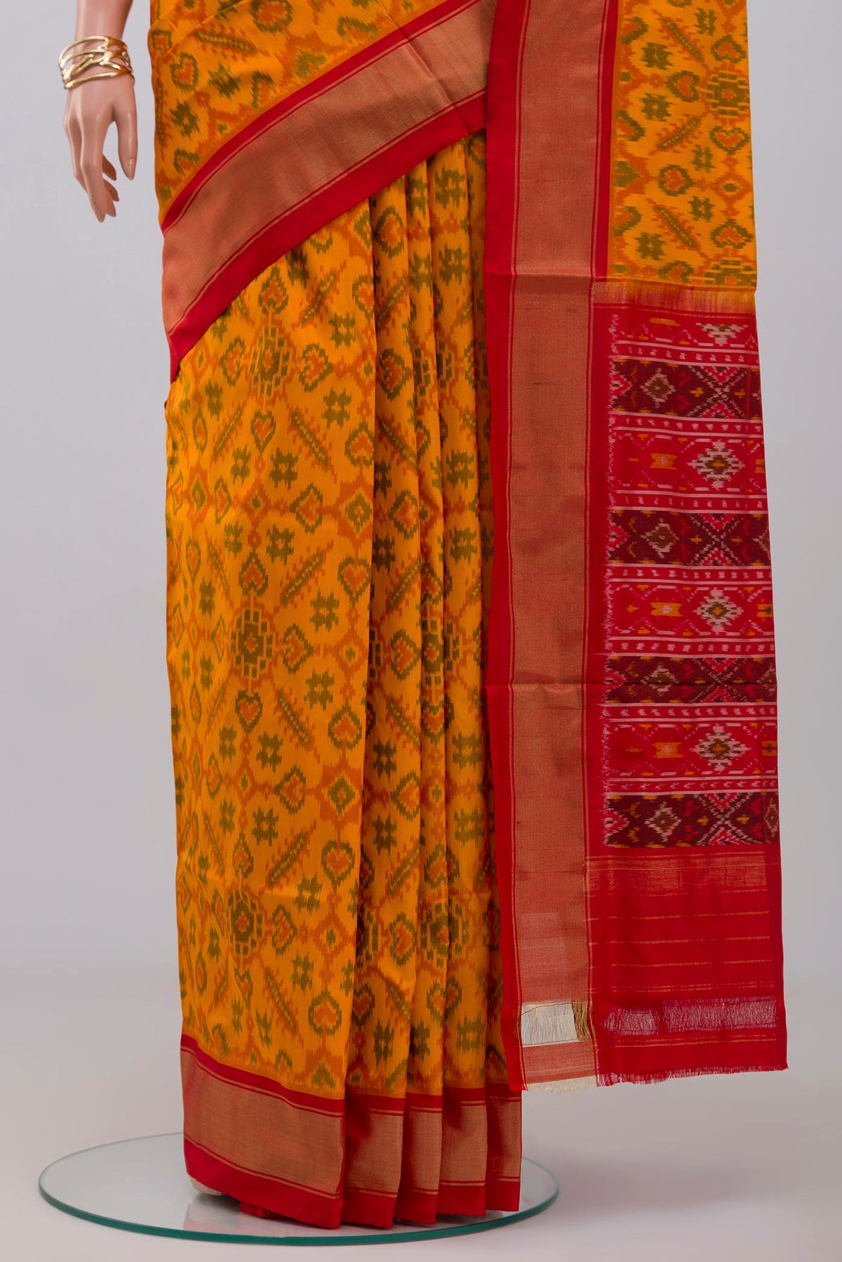 Pleats and pallu of Yellow Pochampally Silk Saree with Ikat design on the body and Zari Border. 