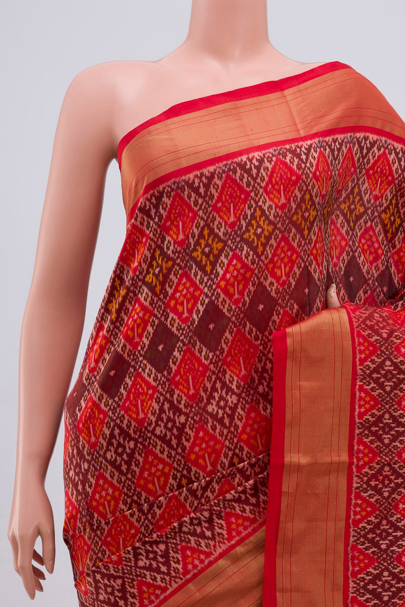 Border image of Orange Pochampally Silk Saree with Ikat design on the body and Zari Border. 