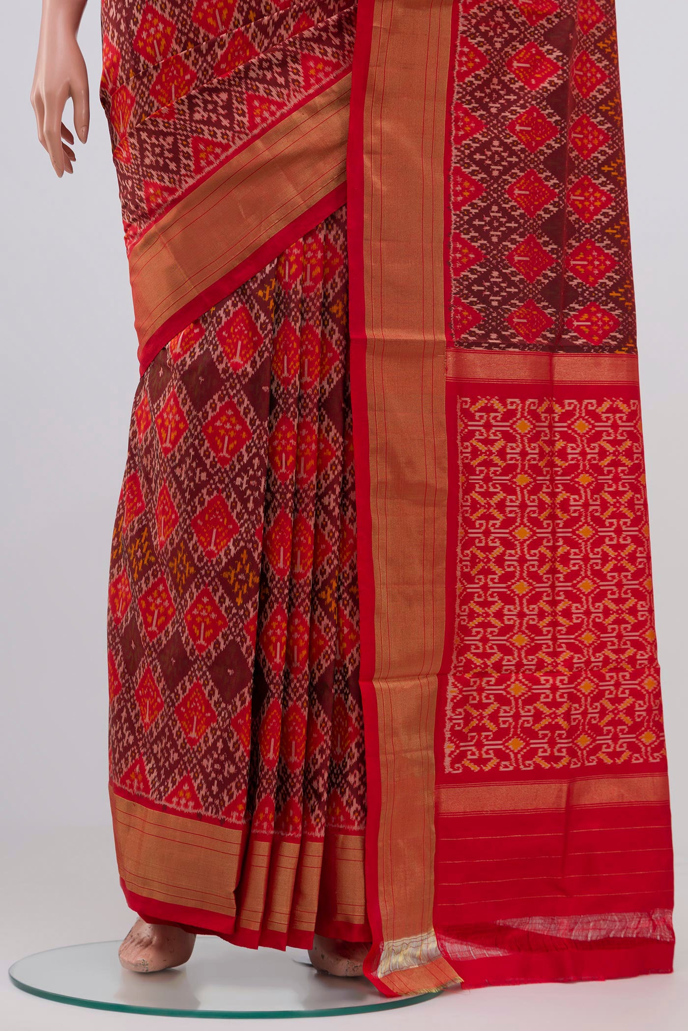 Pleats and pallu of Orange Pochampally Silk Saree with Ikat design on the body and Zari Border. 