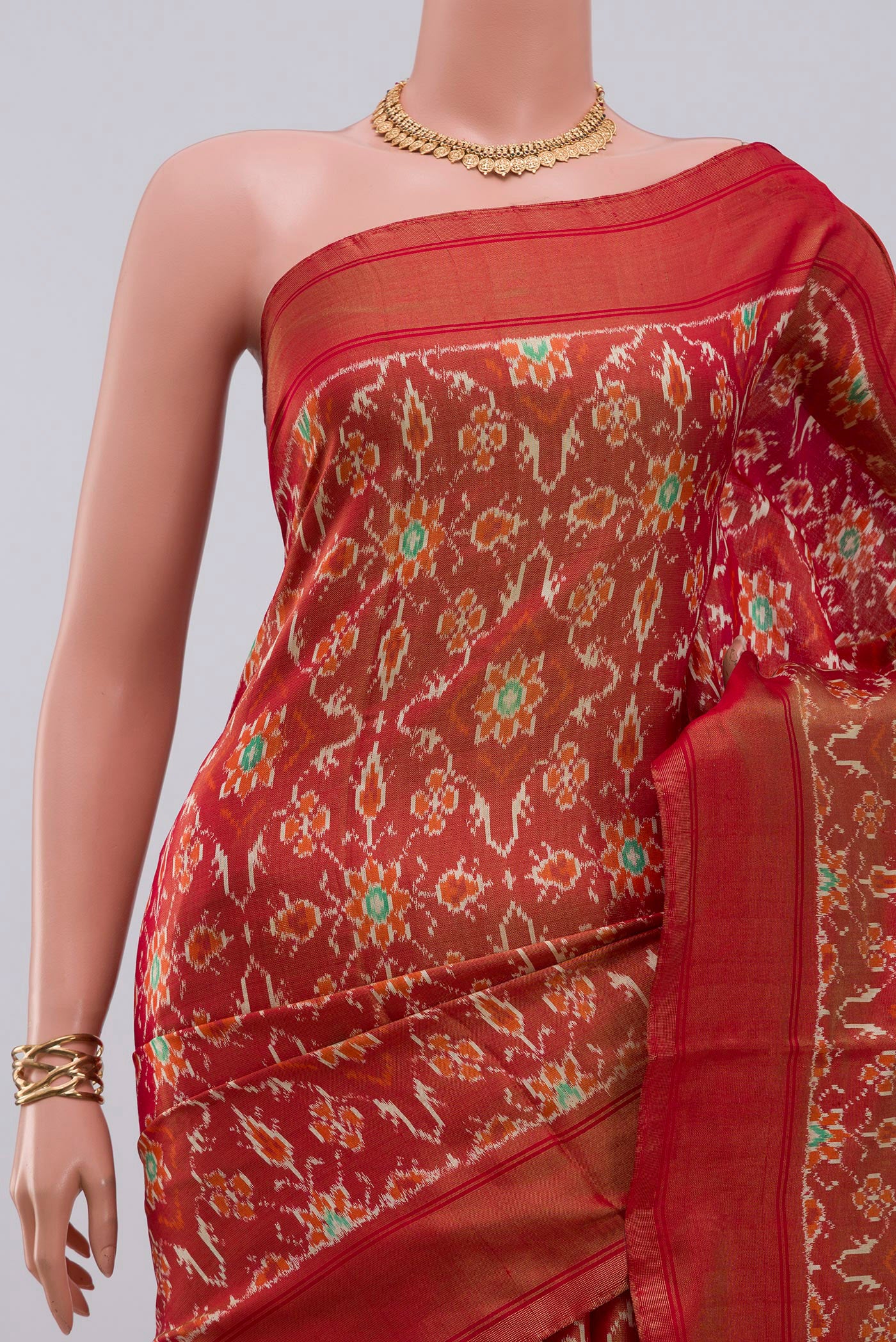 Border image of Rust Pochampally Saree with Ikat design on the body and Zari Border. 