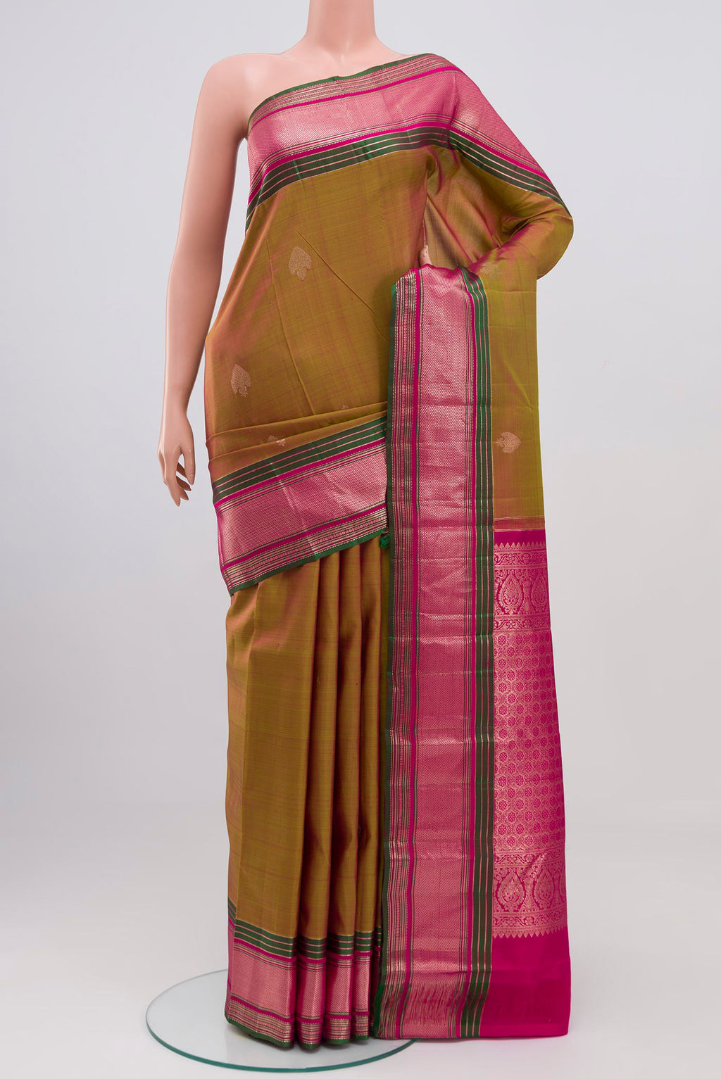 Green Kanjivaram Saree with Zari Butta on the body and Zari Border.  displayed on a mannequin