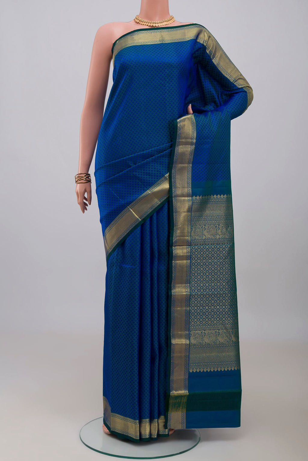 Blue Kanjivaram Silk Saree with Jacquard design on the body and Zari Border.  displayed on a mannequin